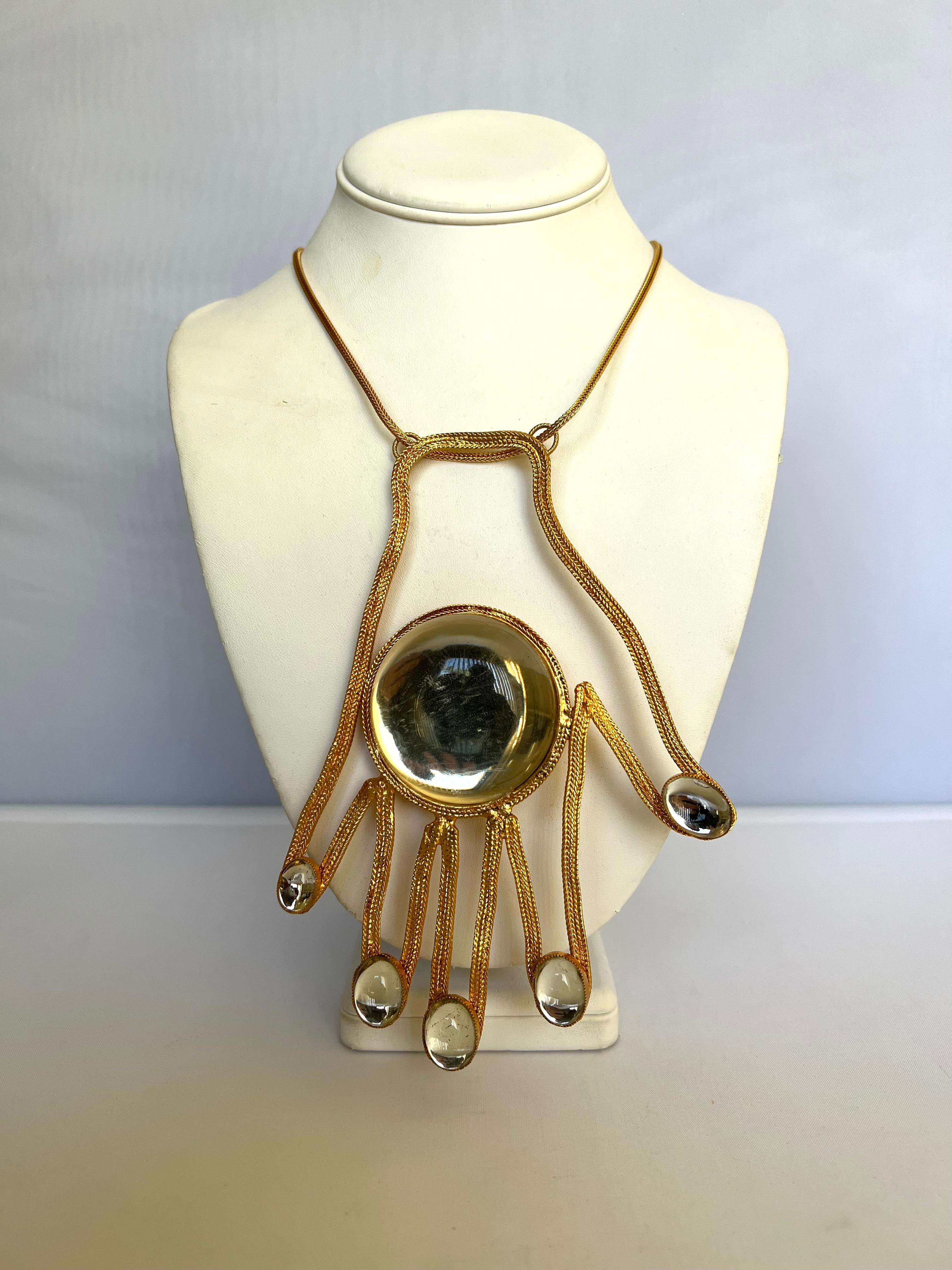 Scarce massive gold-plated pendant necklace featuring a large three-dimensional hand with jelly-belly elements. Signed, Robert F. Clark for William de Lillo ltd. New York, circa 1971. The necklace was featured in Vogue (April 1971); please see the