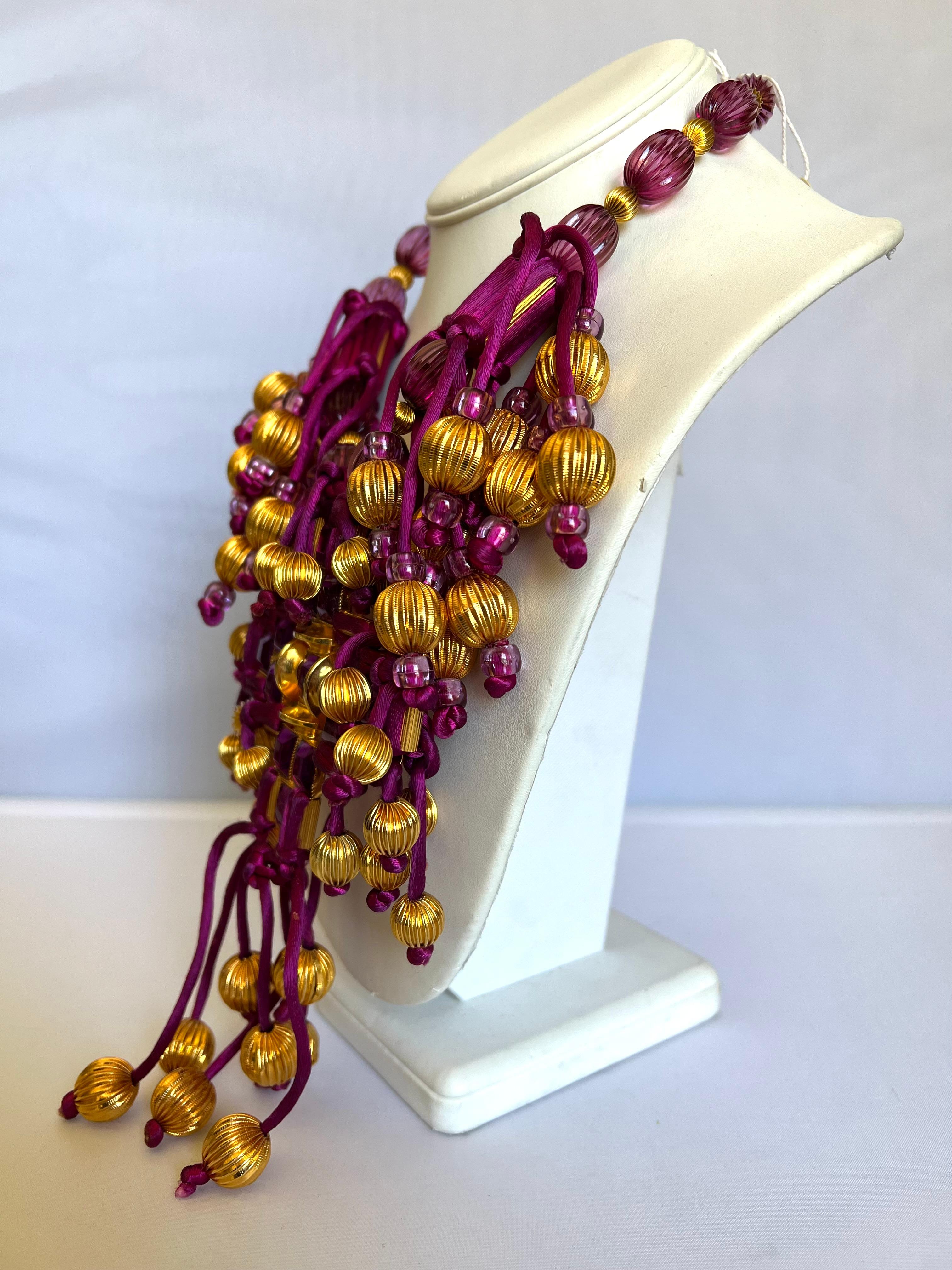 One-of-a-kind mixed material fringe statement necklace by William de Lillo/Robert F. Clark for Madame. Gres Haute Couture (spring/summer 1975). The museum-quality necklace features mixed materials such as purple silk tassels, large gold-tone ribbed