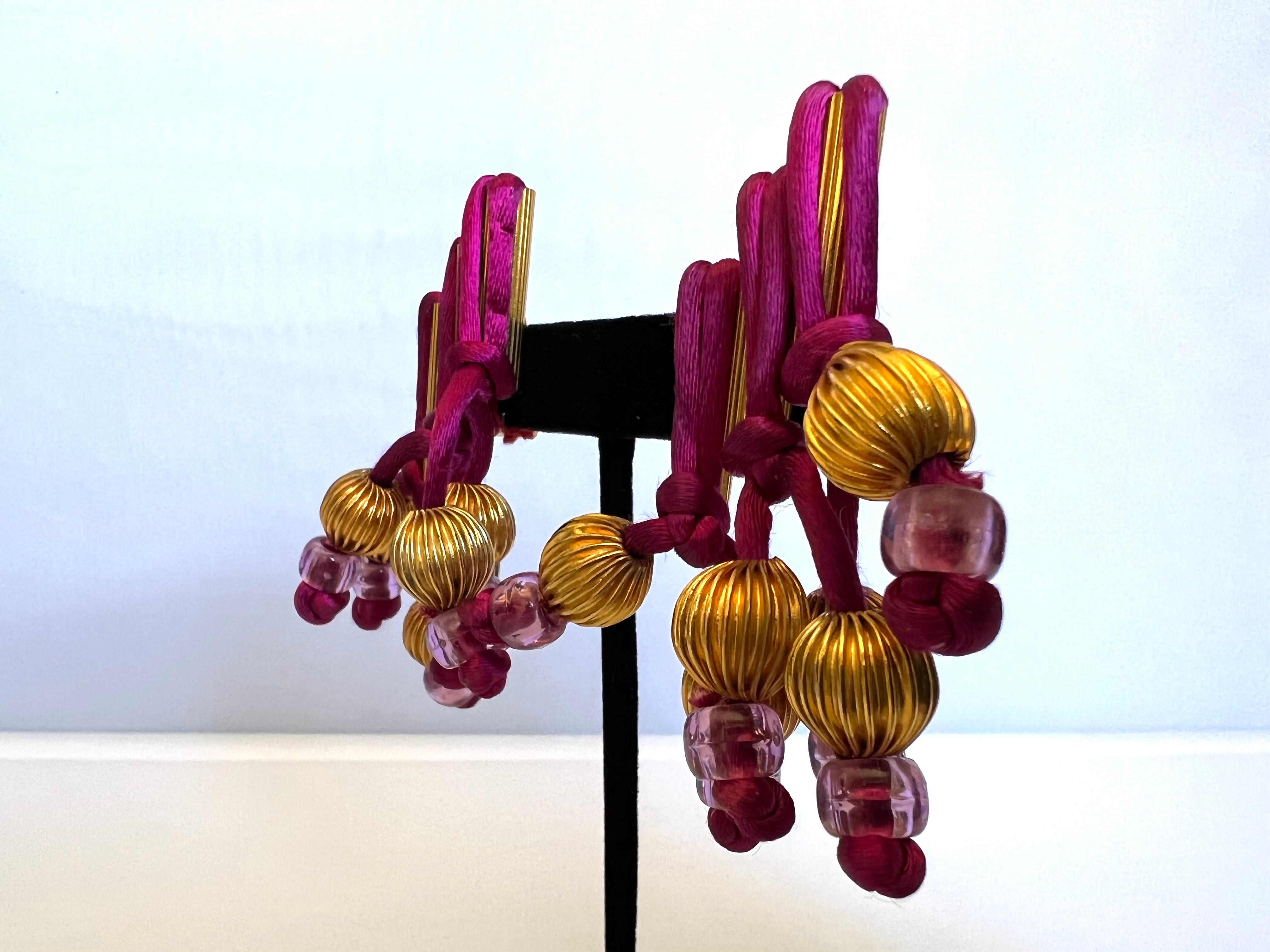 One-of-a-kind mixed material fringe statement clip-on earrings by William de Lillo/Robert F. Clark for Madame. Gres Haute Couture (spring/summer 1975). The museum-quality earrings feature mixed materials such as purple silk tassels, large gold-tone