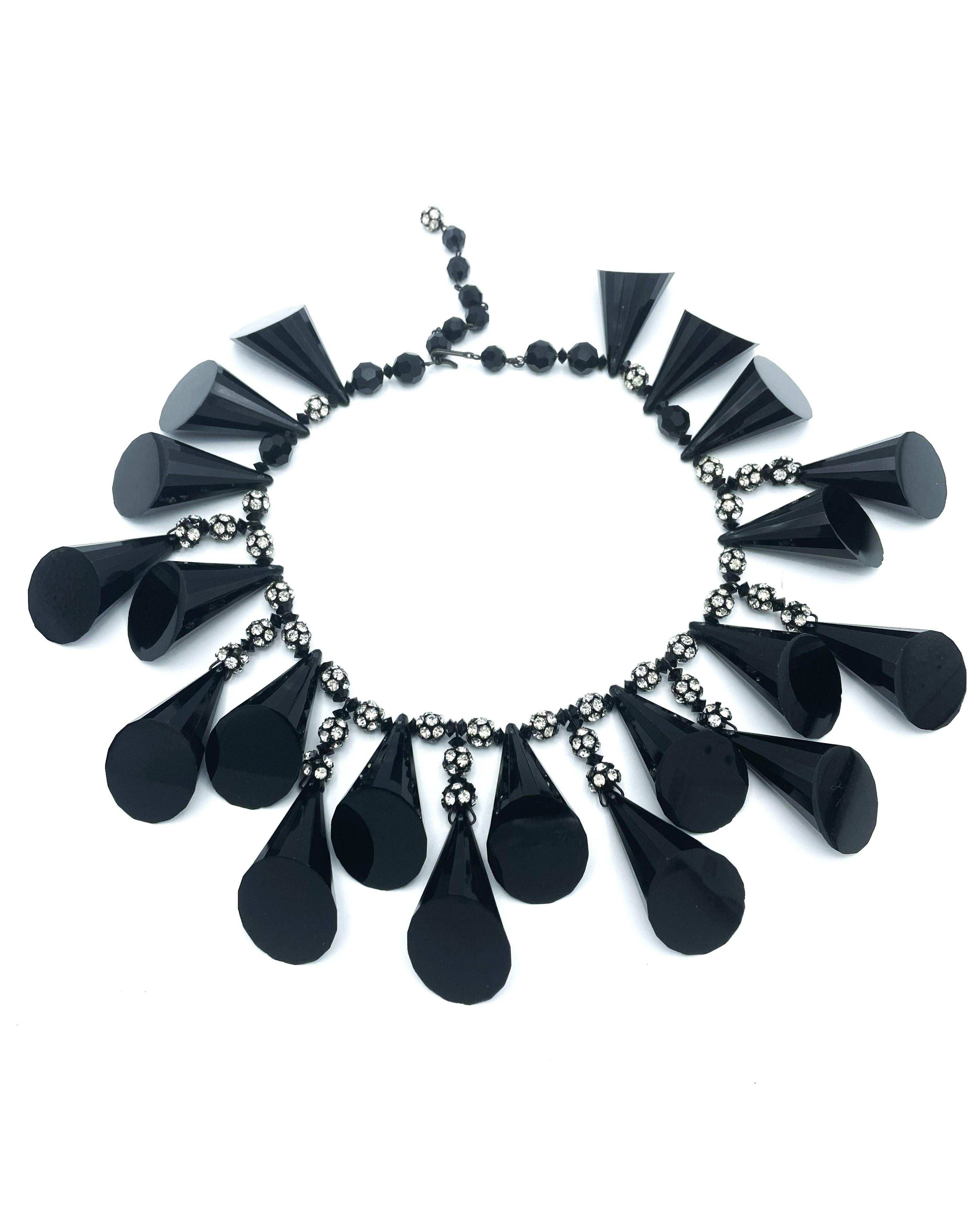 Vintage necklace by De Lillo from the early 1970s in New York. Consists of 12 black, conical, angular, polished bakelite  pendants. These hang from small rhinestone-studded balls. The necklace also consists of small rhinestone-studded balls that