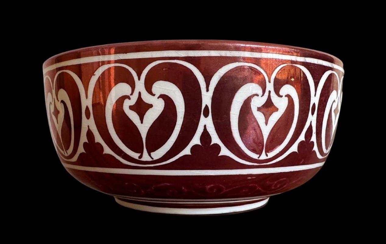 5397
William De Morgan Ruby Lustre Bowl
Decorated by with Fish to the interior and Persian decoration to the exterior by Fred Passenger.
Small glaze frits to the rim
19cm wide, 9 cm high
Circa 1890.