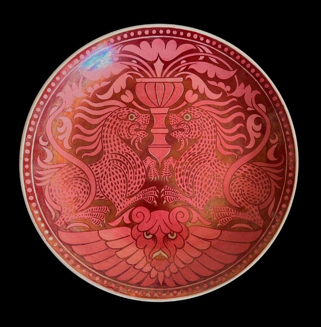 5413
William De Morgan Ruby Lustre Charger decorated with Symmetrical Mythical Beasts with Green Eyes, a Vase and a Lion Mask by Fred Passenger
Superficial scratches to the interior
37cm wide, 5.5cm deep
circa 1880.