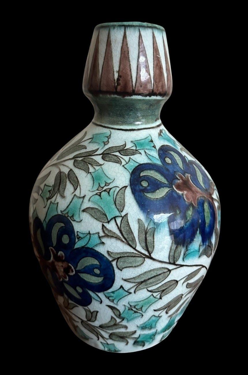 5388
William De Morgan Jug decorated with Flowers and Foliage in the Persian Palate, with a turquoise handle. Small frit to rim.
23.5cm high, 16cm wide
circa 1880.