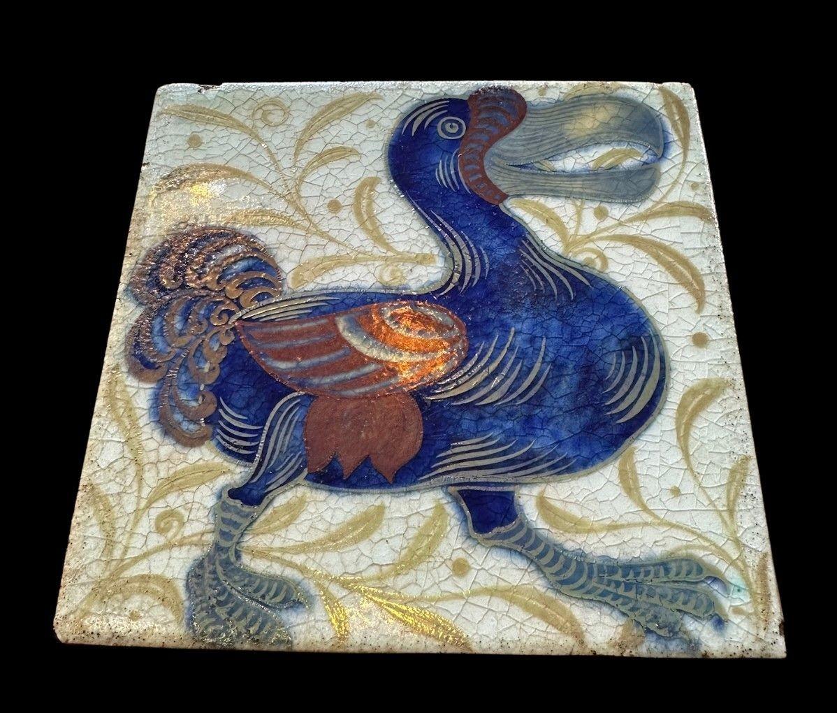 5515
William De Morgan Triple Lustre Tile decorated in the “Dodo” design
15.3cm x 15.3cm
1898
Provenance:
Purchased by the Earl of Balfor (UK Prime Minister 1902 - 1905) directly from William De Morgan, thence by descent
Small chip to top edge and