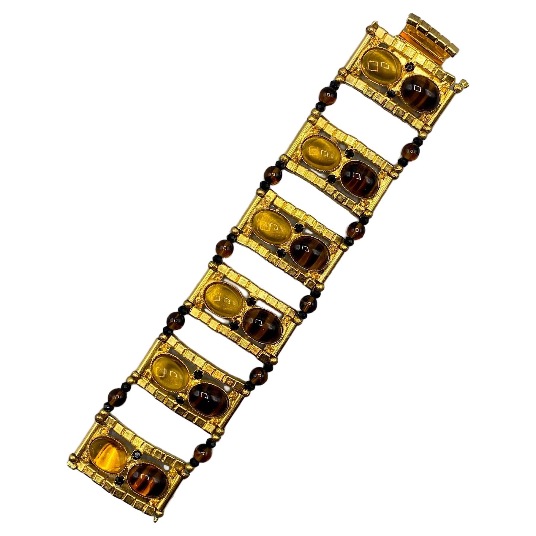 A truly wonderful wide bracelet, circa 1974, by Avant-garde fashion jewelry designer William DeLillo of NYC. The bracelet is in the Egyptian revival style popular in the early 1970s. It is comprised of 6 rectangular and lightly domed .75 inch wide