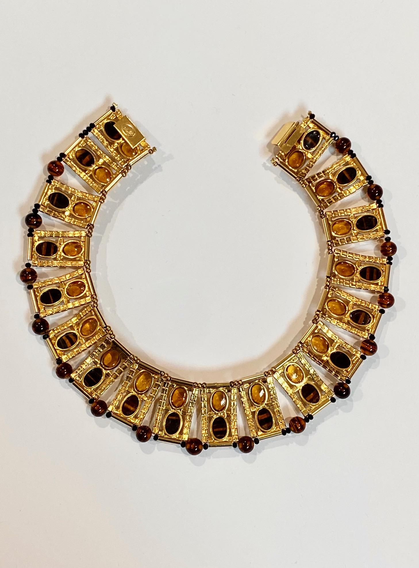 A truly elegant statement necklace, circa 1974, by Avant-garde fashion jewelry designer William DeLillo of NYC. The necklace is in the Egyptian revival style popular in the early 1970s in its wide link collar design. The necklace is comprised of 18