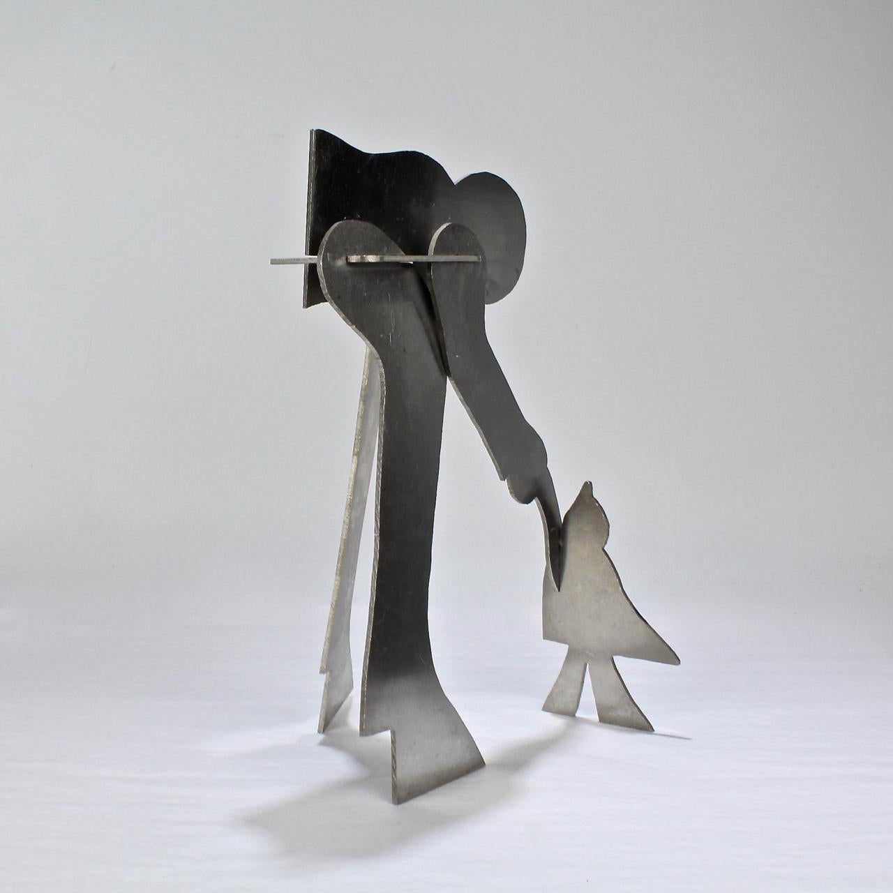 A Mid-Century Modern aluminum sculpture of a man and a bird (or perhaps a child?).

William D. King (1925-2015)

This interlocking aluminum sculpture was one of a series, which were sold principally in museum gift shops in the 1960s-1970s during