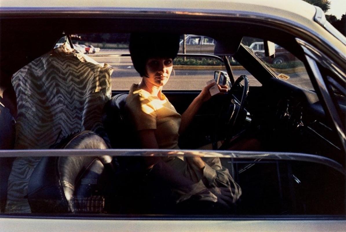William Eggleston Color Photograph - Untitled (Woman in Car with Drycleaning)