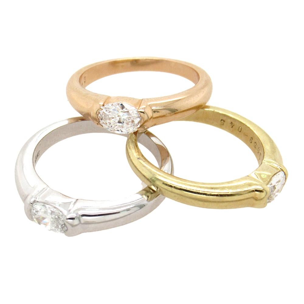 From a private estate, a perfect set of diamond rings by the legendary diamantaire William Goldberg. Each ring is set horizontally with a 0.45 carat oval cut diamond, in 18K yellow gold, 18K white gold and 18K rose gold.  The rings measure 3/4