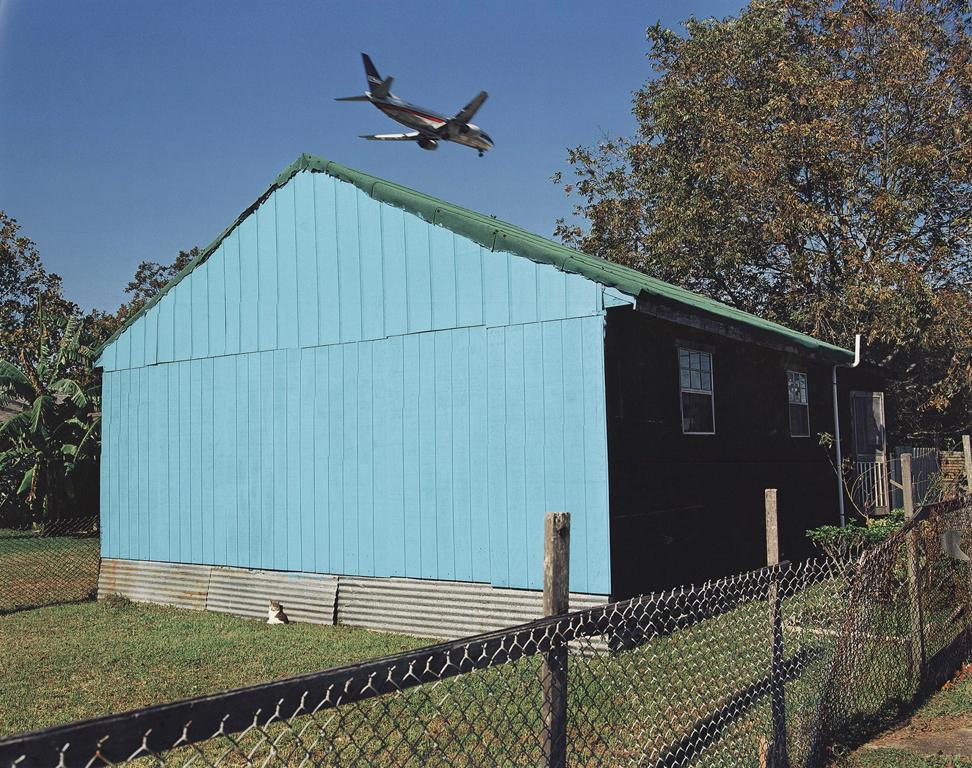 William Greiner Figurative Photograph - Jet Over Blue & Black House