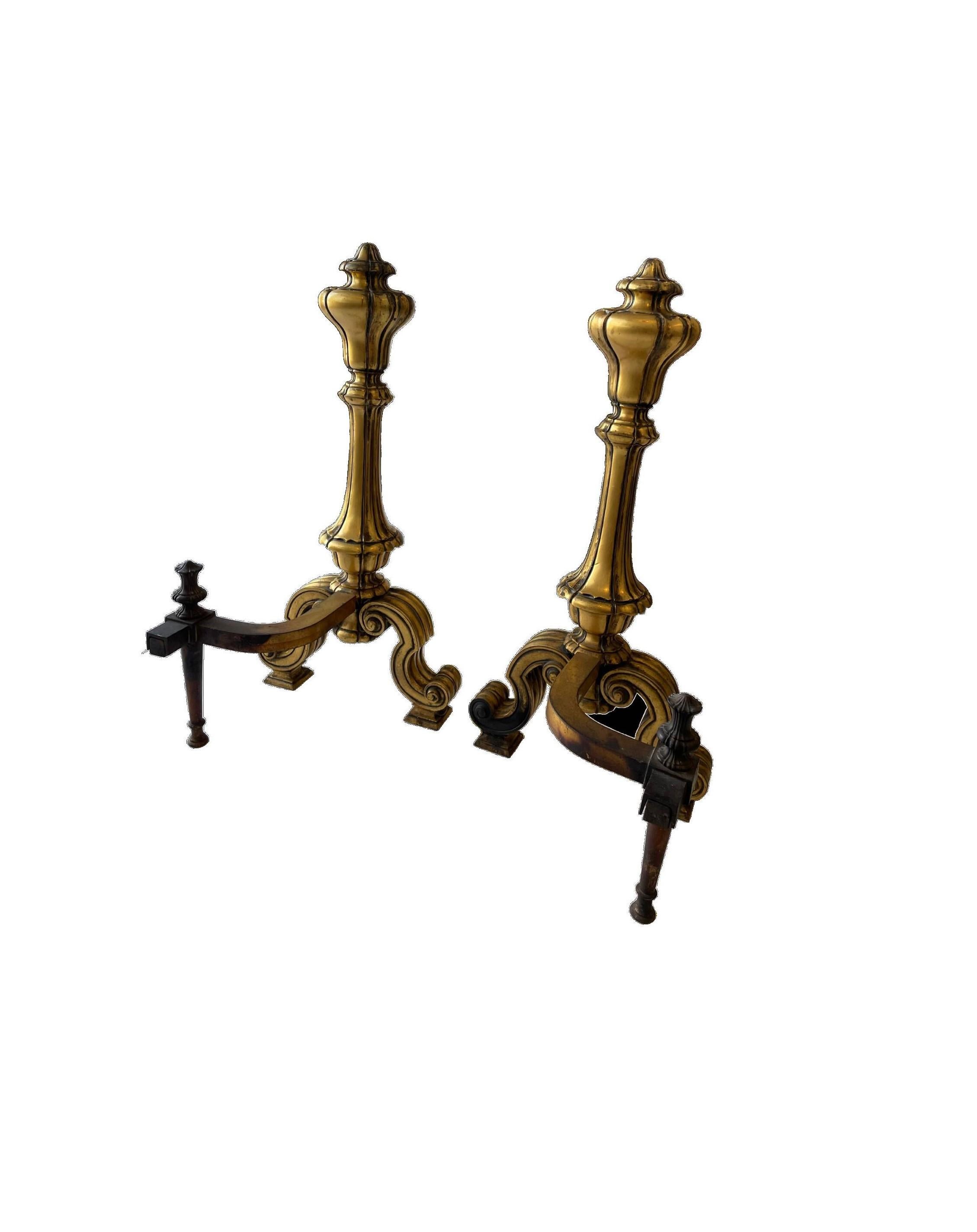 Large-scale ornate set of andirons with beautiful brass detailing and curved scroll feet will stand out in any stately fireplace. Complete with gorgeous gilded brass and pewter set of 4 piece fireplace tools and stand. 
