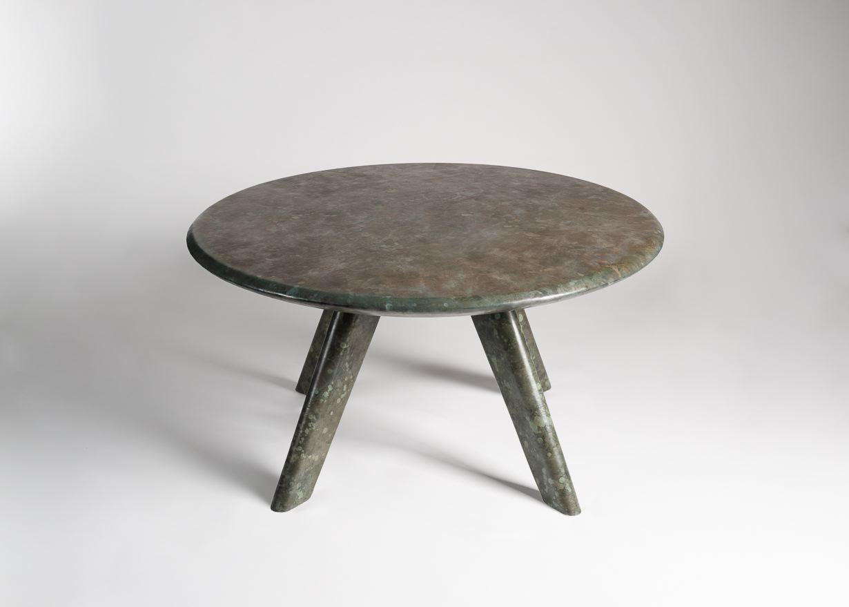 This charming occasional table clad in green 