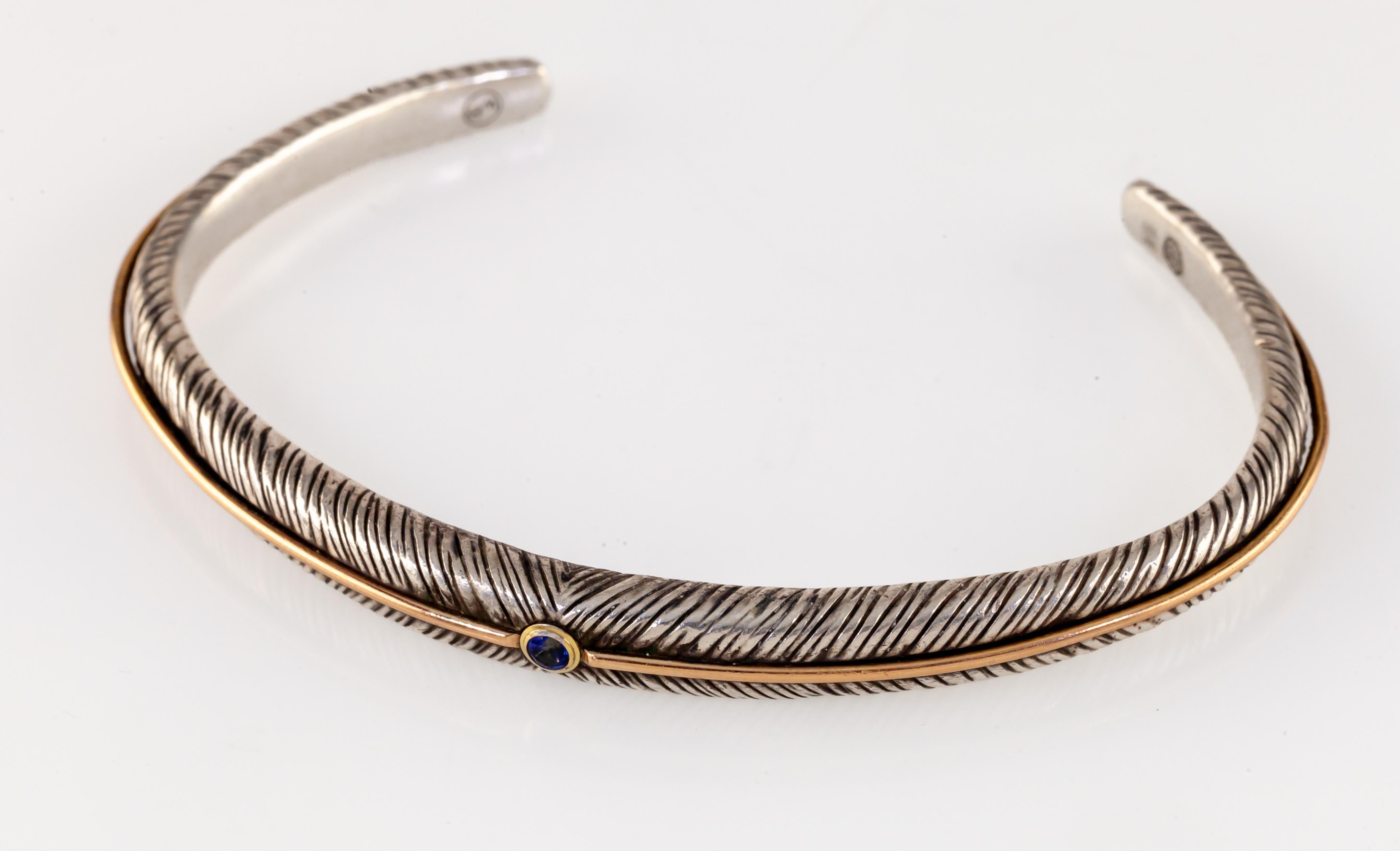 William Henry Sterling Silver and 18k Rose Gold Tudor Rose Cuff Bracelet

Gorgeous, Unique Bracelet by William Henry
Part of the Tudor Rose Collection
Feather Accented Solid Sterling Silver Cuff with Sapphire Accent and 18k Rose Gold Accent