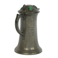 William Hutton. An Arts and Crafts pewter jug with four bullseye Ruskin jewels