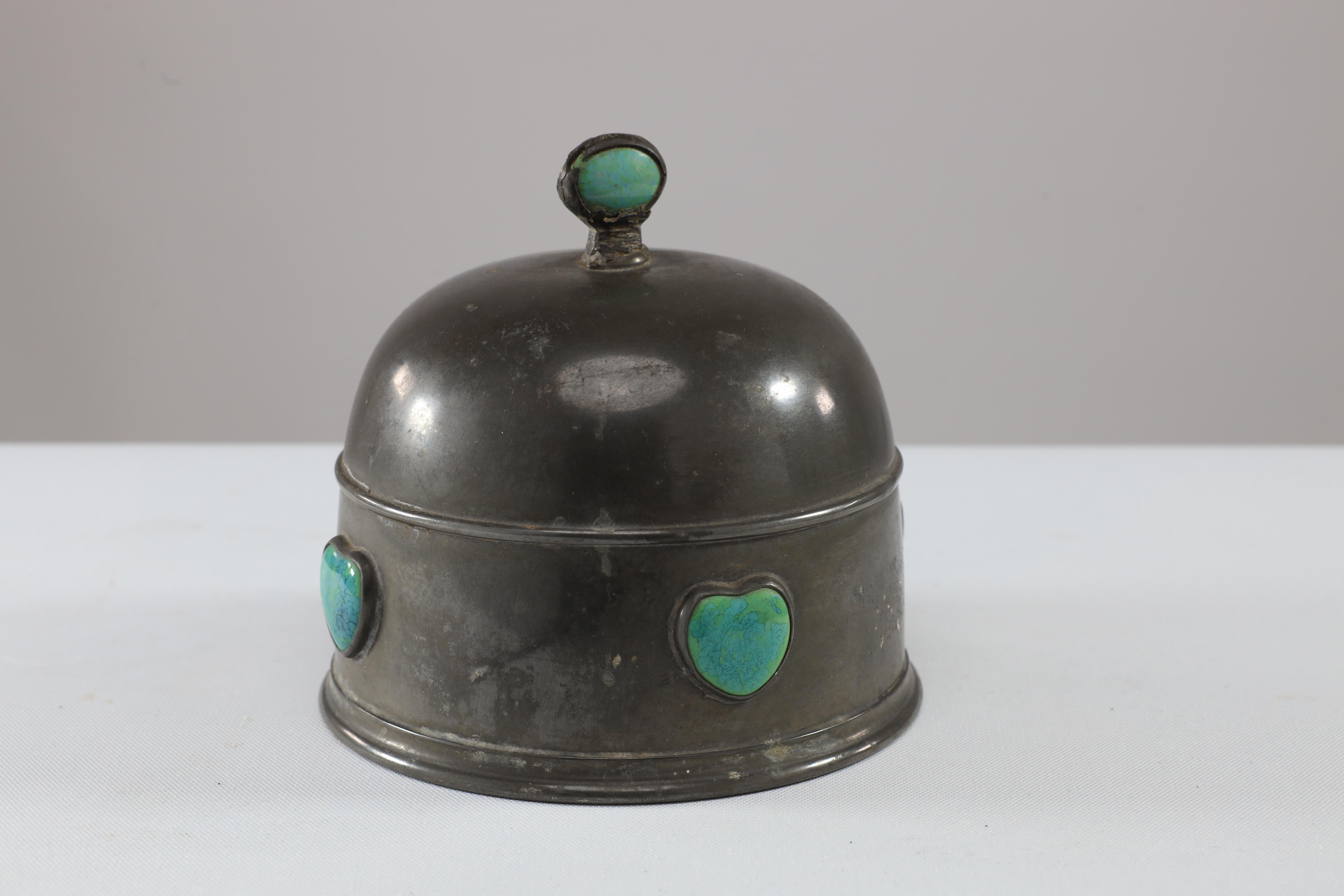 William Hutton, probably for Liberty and Co. An Arts and Crafts pewter muffin cover, inset with two opposing Ruskin jewels to the finial, and four heart shaped Ruskin jewels to the sides, all in perfect condition.