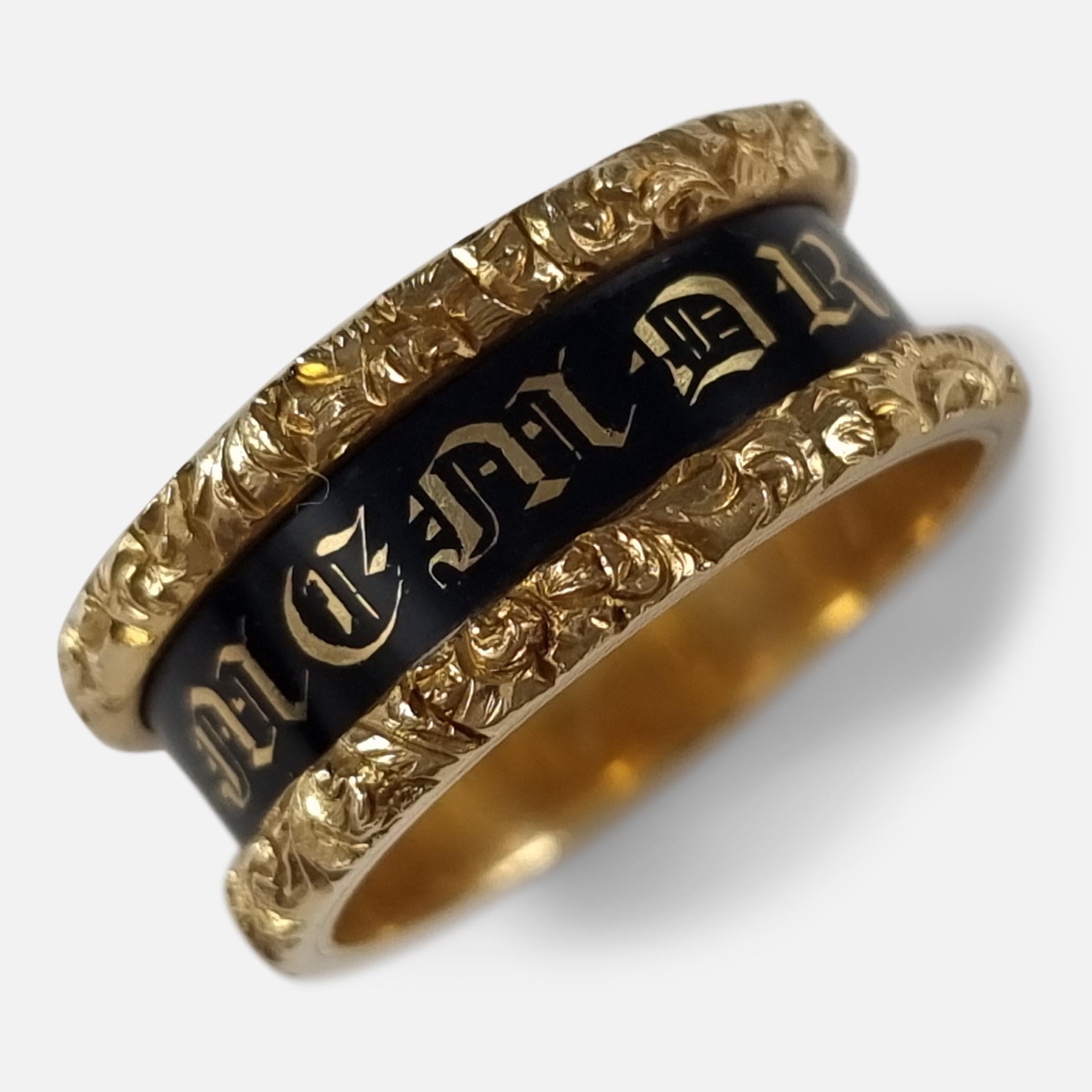 A William IV 18ct yellow gold and black enamel memorial mourning ring.

The band reads 'IN MEMORY OF' within gold foliate border, and is inscribed to the interior 'Owen Rees, Esq Ob 5 Sep 1837, Aet 67.'.

The ring is hallmarked with London marks,
