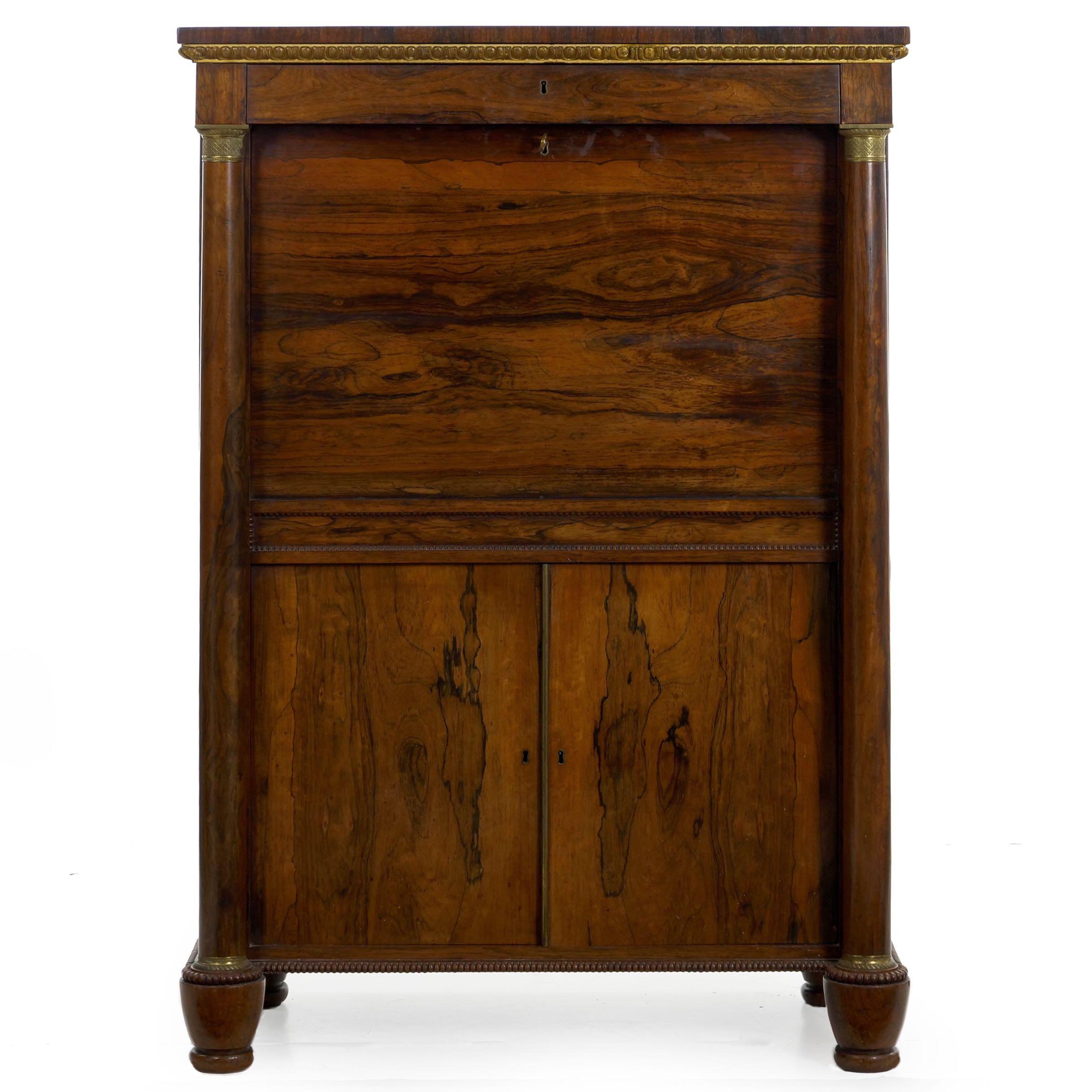 An extremely fine case piece, it exhibits careful craftsmanship, attention to detail and richness of material throughout, circa 1835. A distinctly English interpretation of the generally French “Secrétaire à Abattant“, it is dressed in a chaotic and