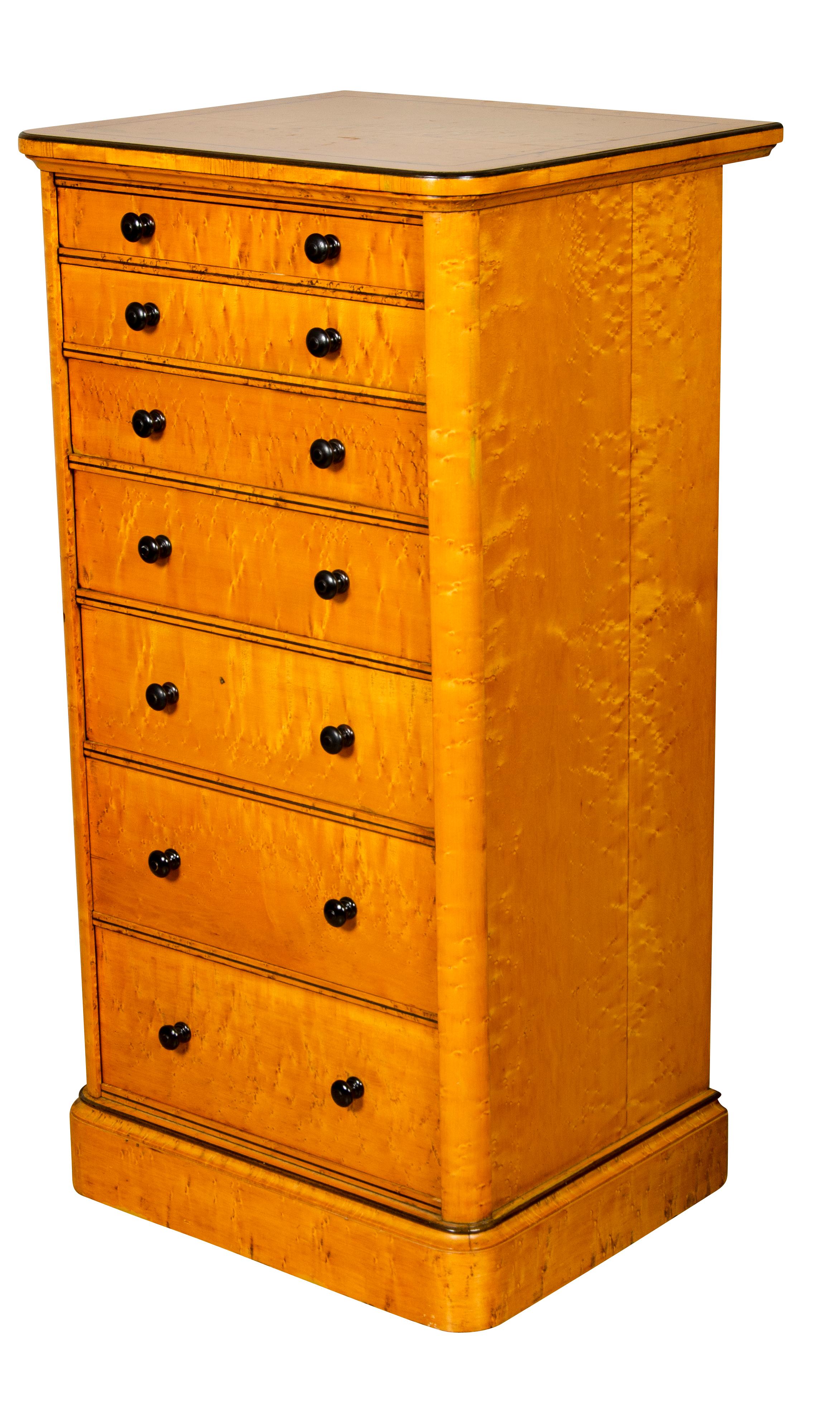 With squarish top with ebony stringing over seven graduated drawers with wood knobs and swinging lock mechanism which locks all drawers, raised on a plinth base. Holland & Sons was an important maker of furniture and rival of Gillows. Commissions