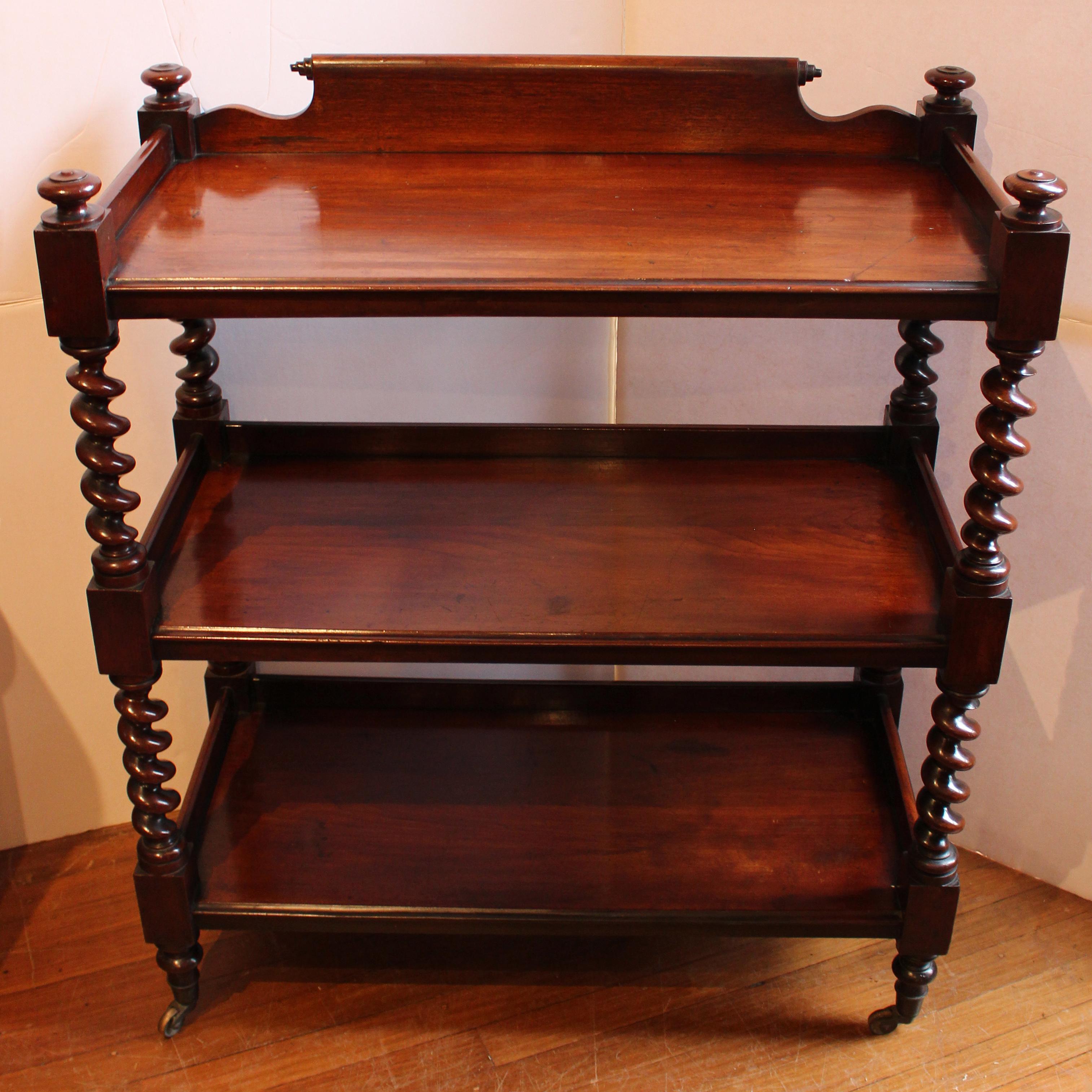 William IV c.1830 etagere serving buffet or buffet trolley. English, mahogany, 3-tiers. Outstanding quality. Shaped backsplat with conical carving at the rail ends, molded edges, barley twist uprights ending in brass caps & casters, surmounted by