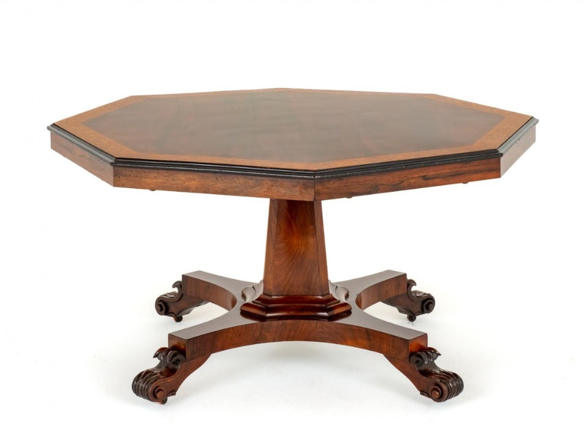 William IV Rosewood Centre Table.
Circa 19th Century
This Table Stands Upon a Quatrefoil Base with Carved Feet and a Shaped Column.
The Top of the Table Being of an Octagonal Form and Features Highly Figured Rosewood Timbers With a Satinwood Border