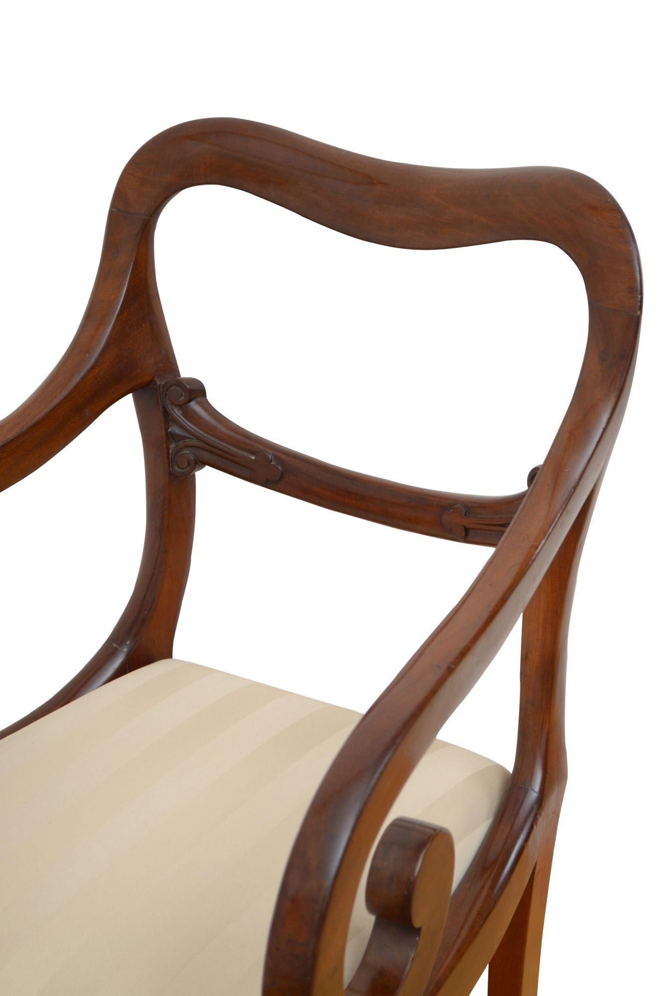 P0244 fine quality, solid mahogany William IV occasional chair, having shaped top rail above carved mid rails and drop in seat upholstered in cream fabric flanked by open scroll arms, all standing on turned, tapered shaped legs. This antique chair