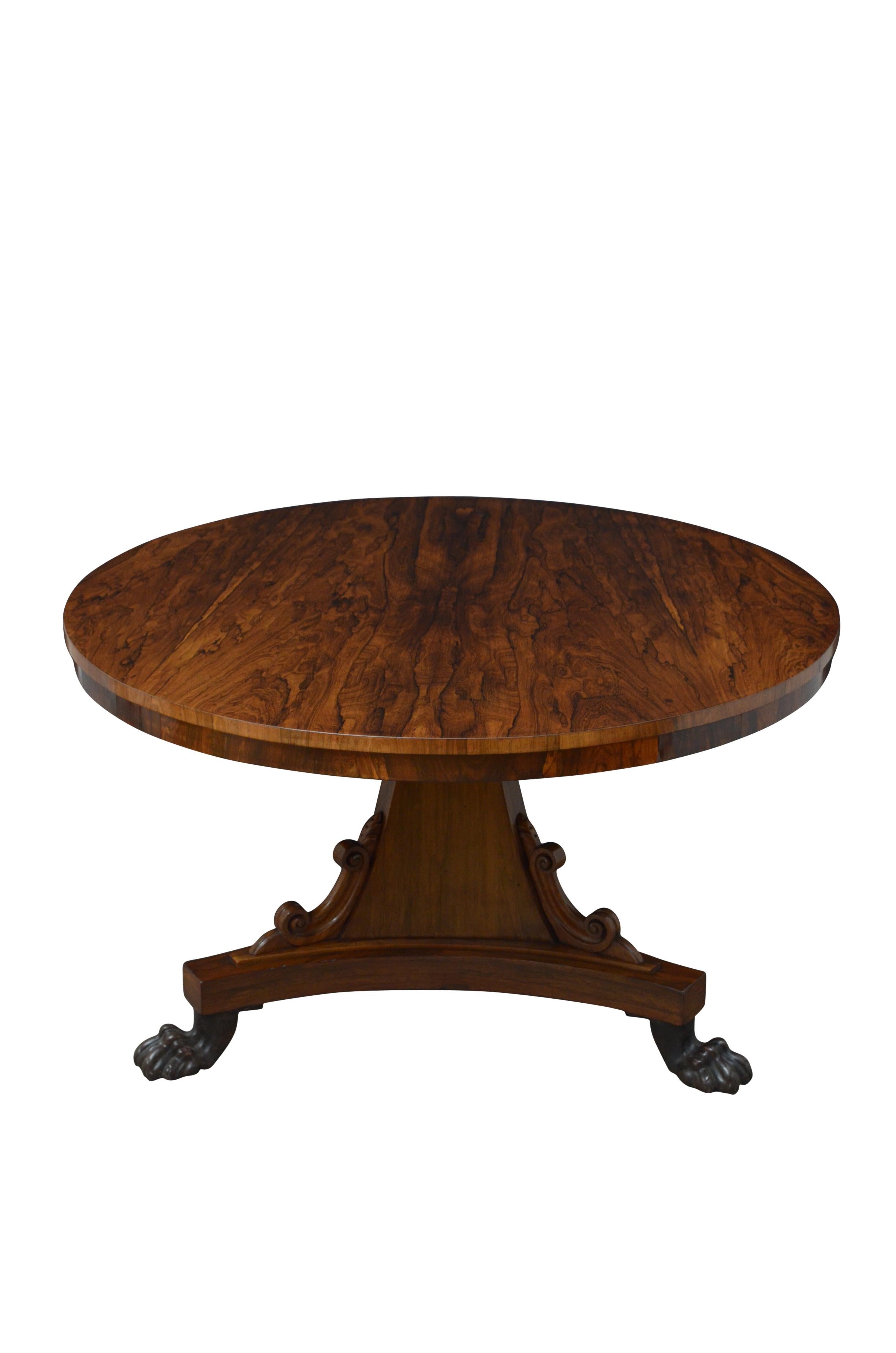 K0503 Superb William IV rosewood dining table / centre table, having tilt top with beautiful and very dramatic grain raised on three sided concave support with carved scrolls terminating in trefoil base and cast metal paw feet. This antique