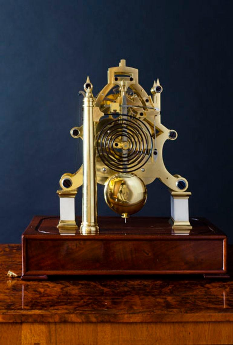 A William IV Skeleton clock of fine quality with two massive scroll plates sitting on rectangular, silvered plinths and standing on a mahogany base with block feet.
 
Eight day double chain fusee movement with six ringed pillars and blued end