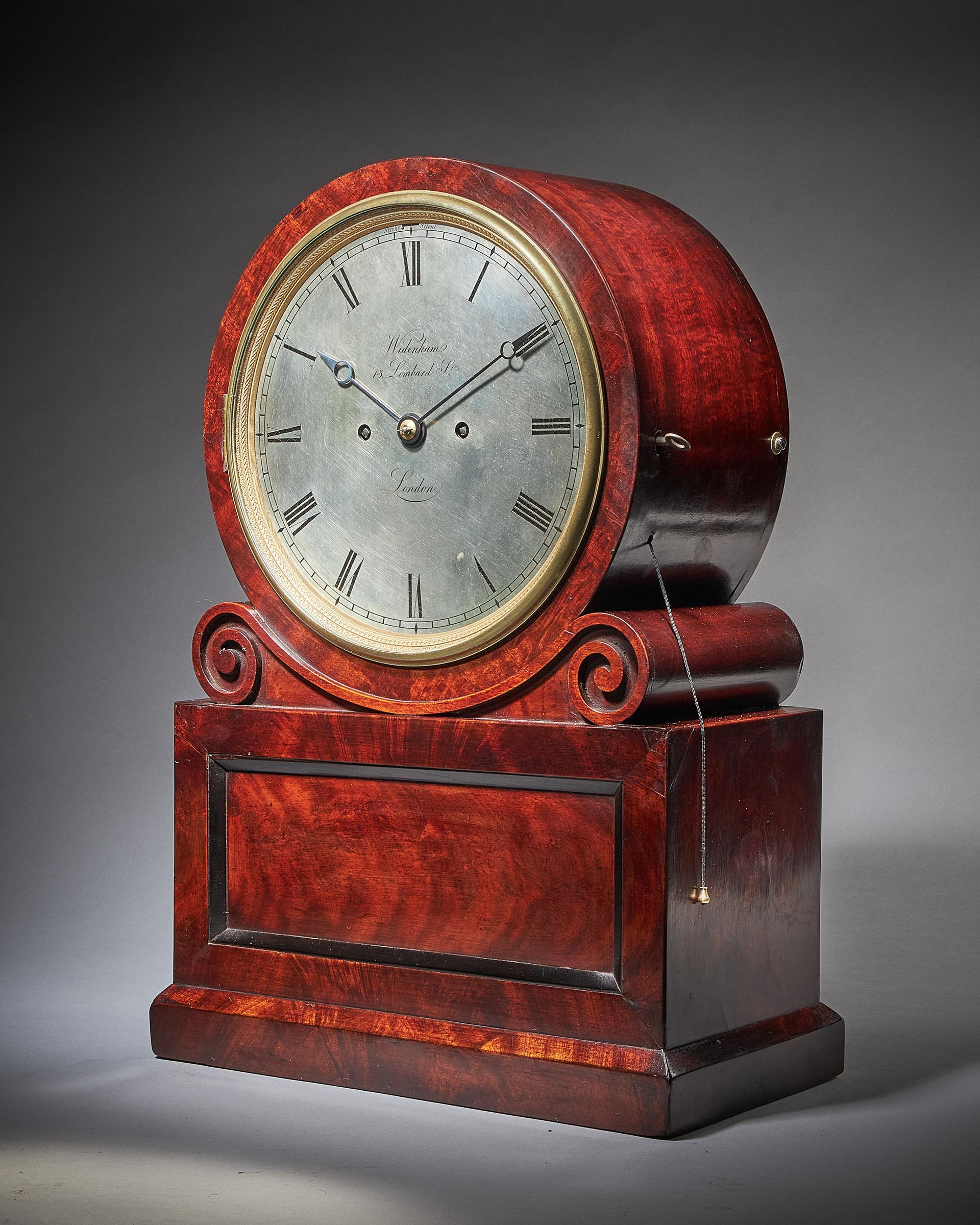 William IV/Early Victorian Table Clock by Widenham, c. 1835-40

This wonderful table clock has a spring-driven eight-day twin chain-fusee movement with going and striking trains with repetition. Unusually, it has circular plates to accommodate the