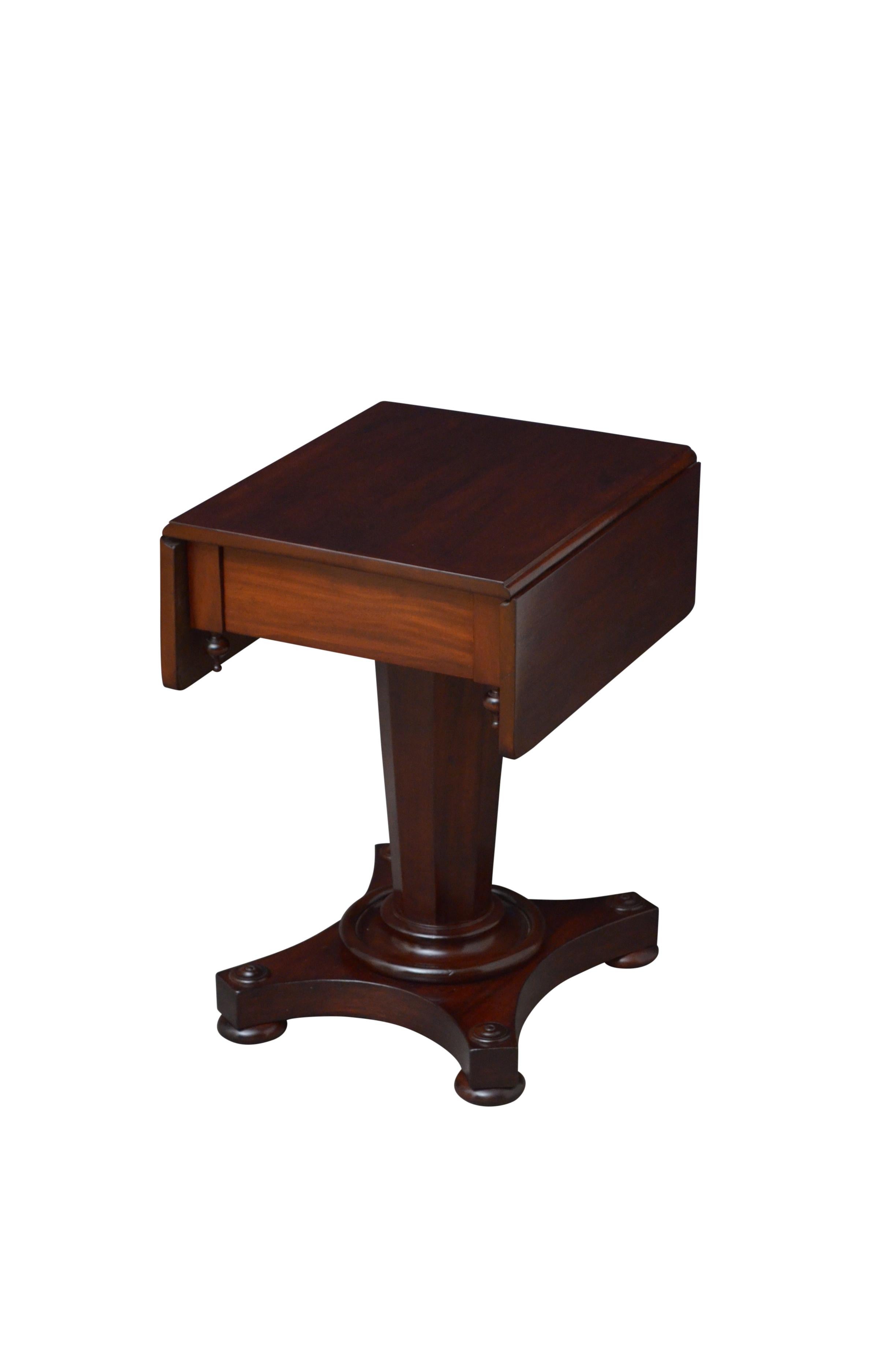M01 elegant mahogany work or lamp table with figured mahogany top above a frieze drawers with four turned finials, raised on flat faceted column terminating in quatrefoil base with decorative paterae and four bun feet. This antique table has been