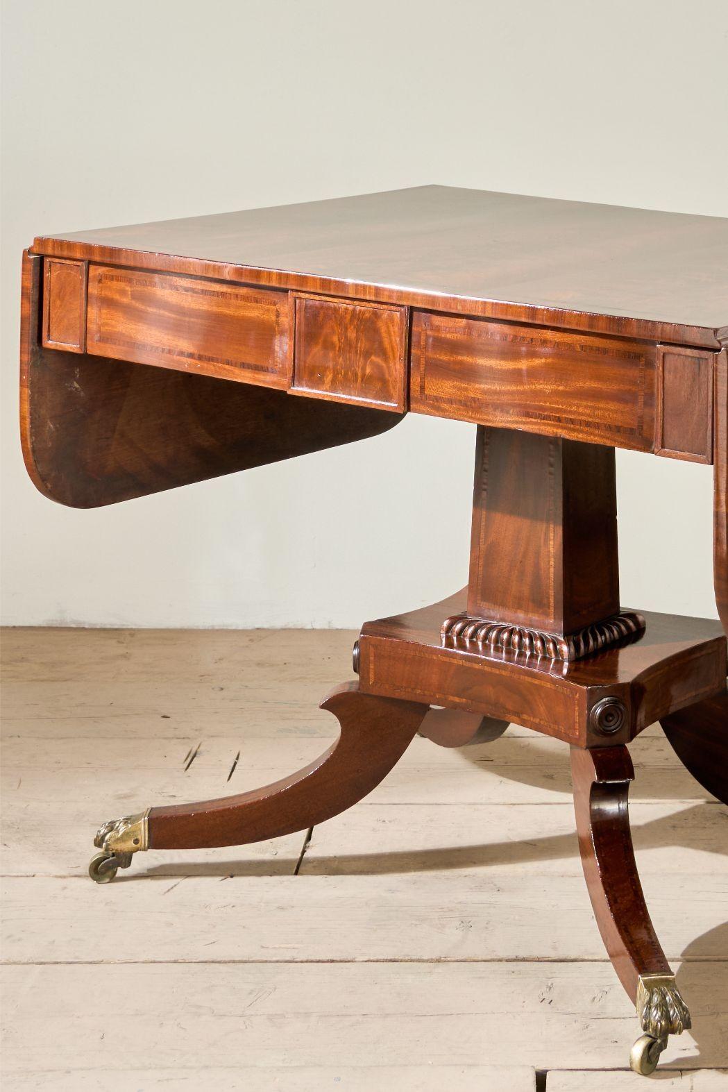 This is a very high quality William IV flame mahogany sofa table with fold down sides. This came from a beautiful house in York and is a very special example. The legs have strung detail and the brass paw casters are totally original. Overall