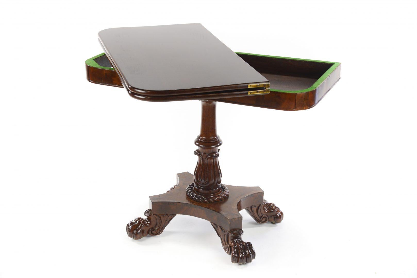 A very good William IV mahogany fold over tea table in the manner of Gillows, with a carved central column sitting on hairy paw feet.

Gillows of Lancaster and London, also known as Gillow & Co., was an English furniture making firm based in