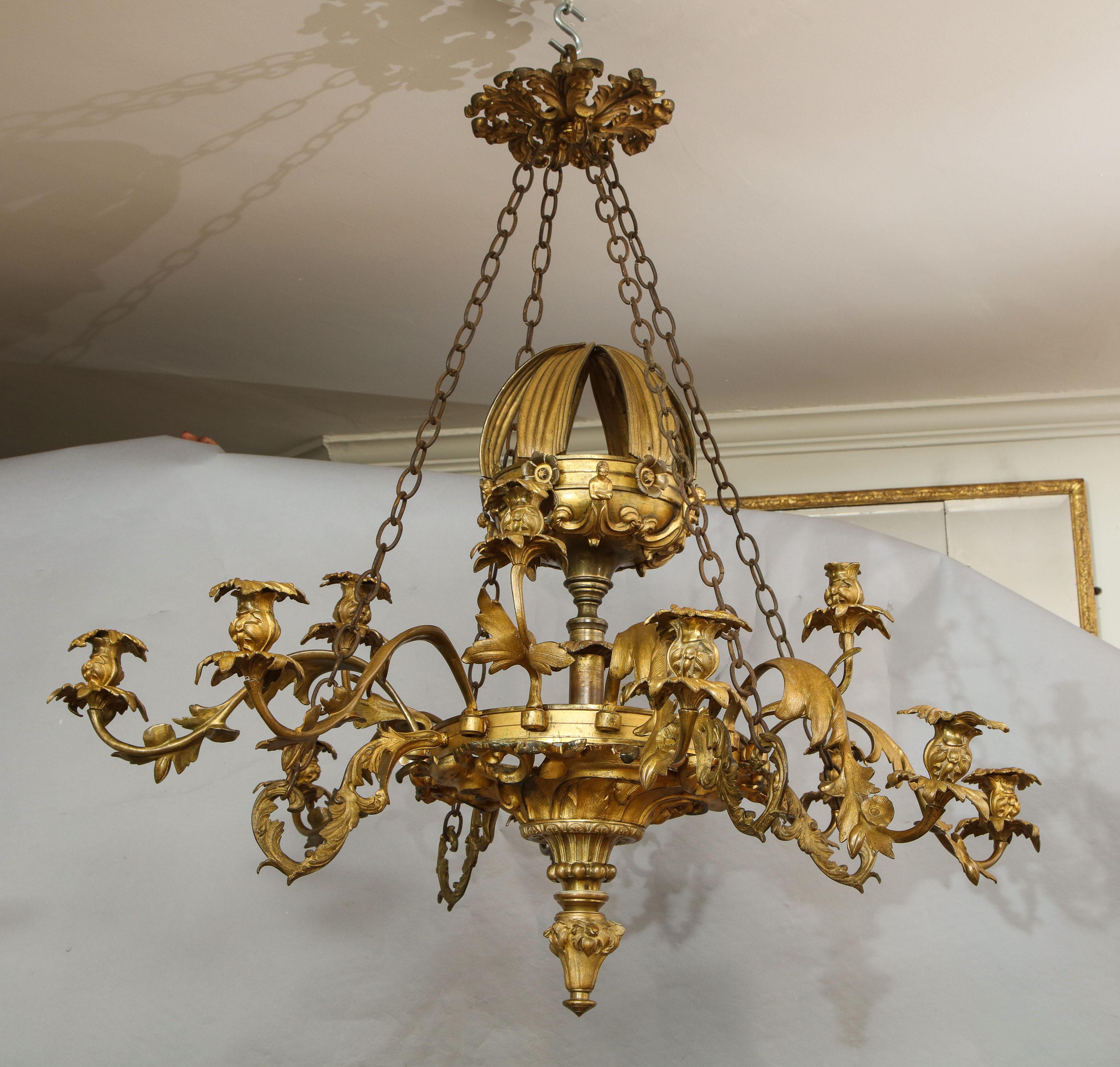 Very fine English gilt bronze 12-light chandelier, in the manner of Thomas Messenger of Birmingham, having chased foliate crown, over four chains supporting scrolled foliate arms, the similarly designed arms of two lengths and heights, the base with