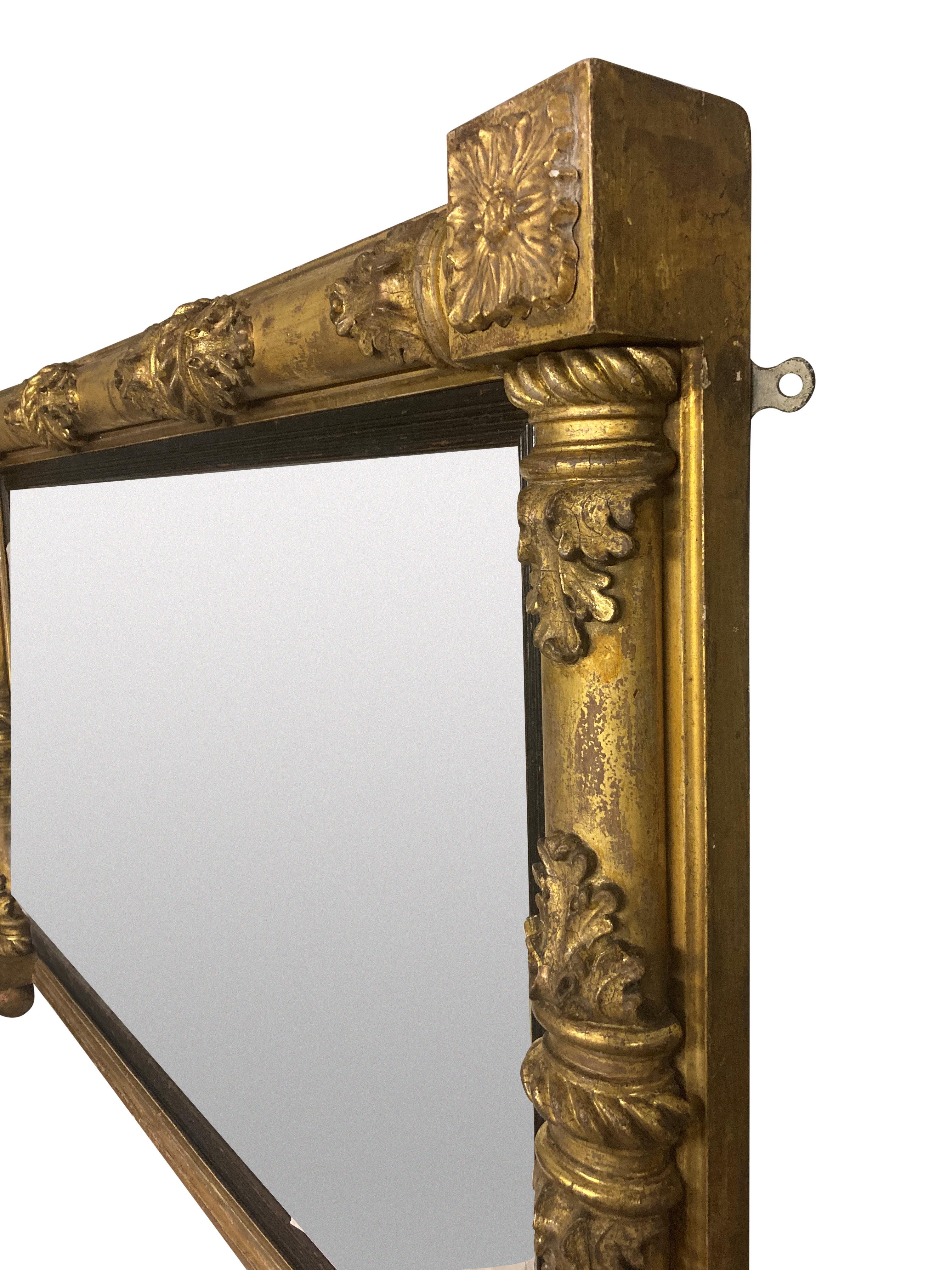 A finely carved and water gilded William IV overmantel mirror, with ebonised slips, mercury plate and depicting acanthus leaves.