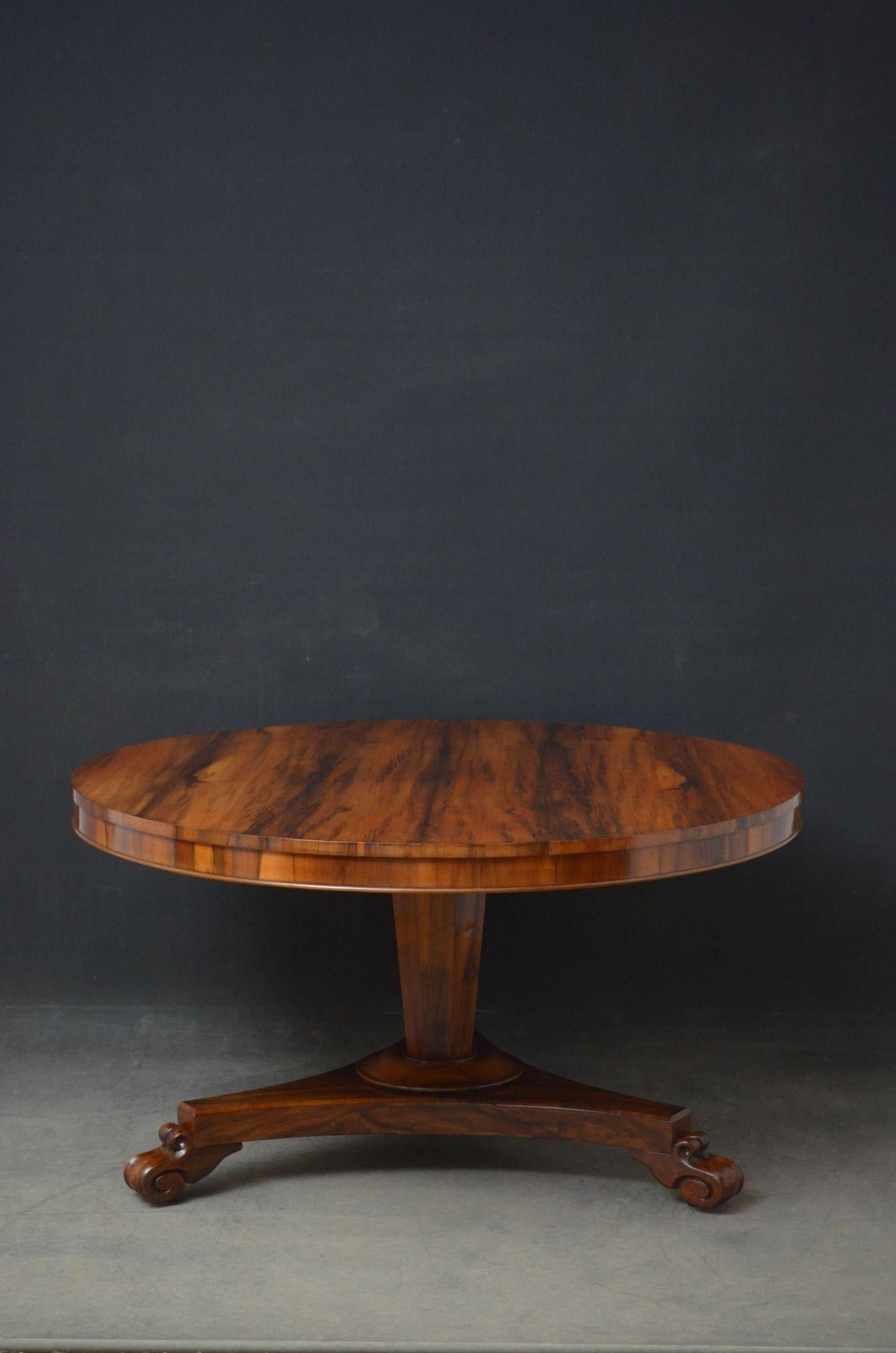 Sn5247 fine quality and rare William IV goncalo alves dining table, having circular top with outstanding contrasting grain above shallow frieze, standing on tapered, flat faceted column terminating in trefoil base, paw feet and castors. This antique