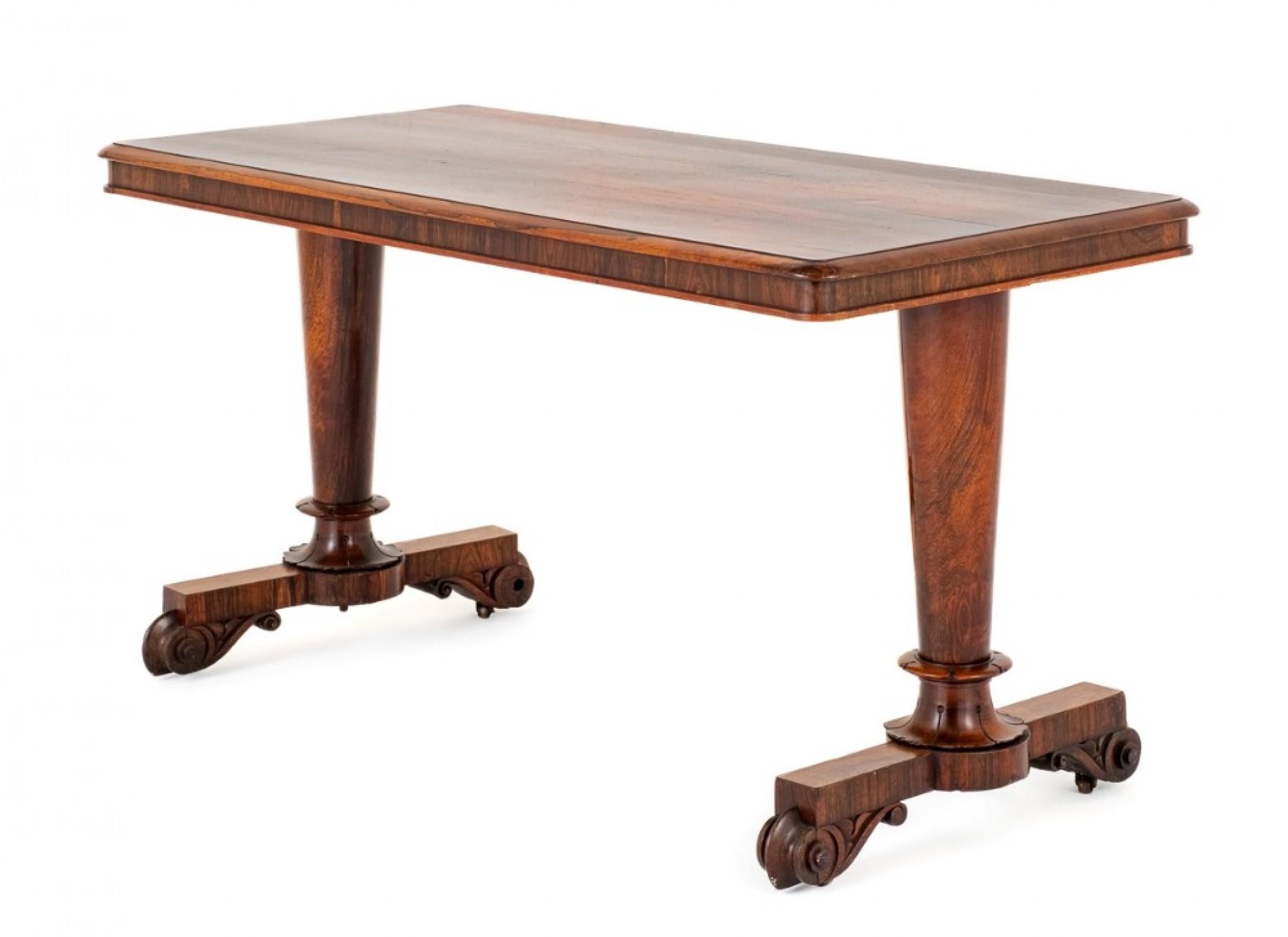 William IV rosewood library table. This library table features a highly figured Rio rosewood top. Circa 1800 The top is supported by turned columns which have turned and carved collars. The piece is finished off with carved feet.
Viewing by