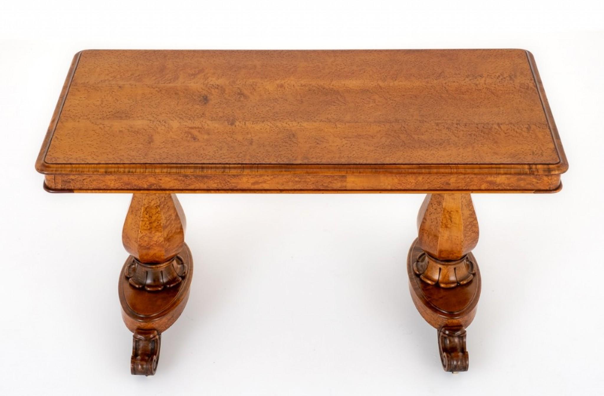 This unusual library table is raised upon bulbous faceted columns, ring turned and carved collars with the bases being of an oval form with carved feet and original brass castors.
circa 19th century
The top of the table featuring thumb mouldings