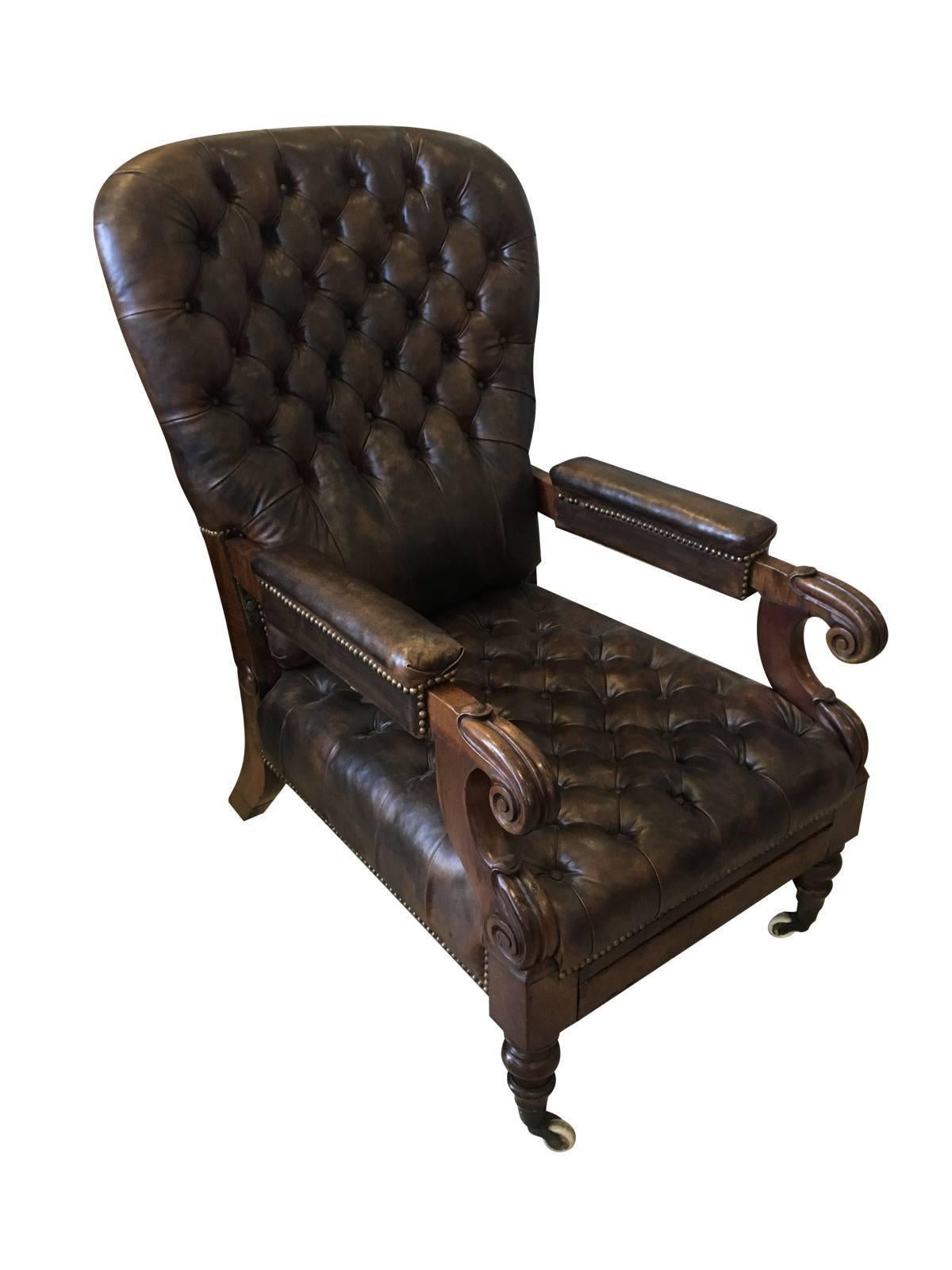 William IV mahogany reclining library chair with reclining back operated with brass pulls to the underside of the arms, as well as a pullout footrest. Recently reupholstered in leather. A comfortable and handsome chair, England, circa 1835.