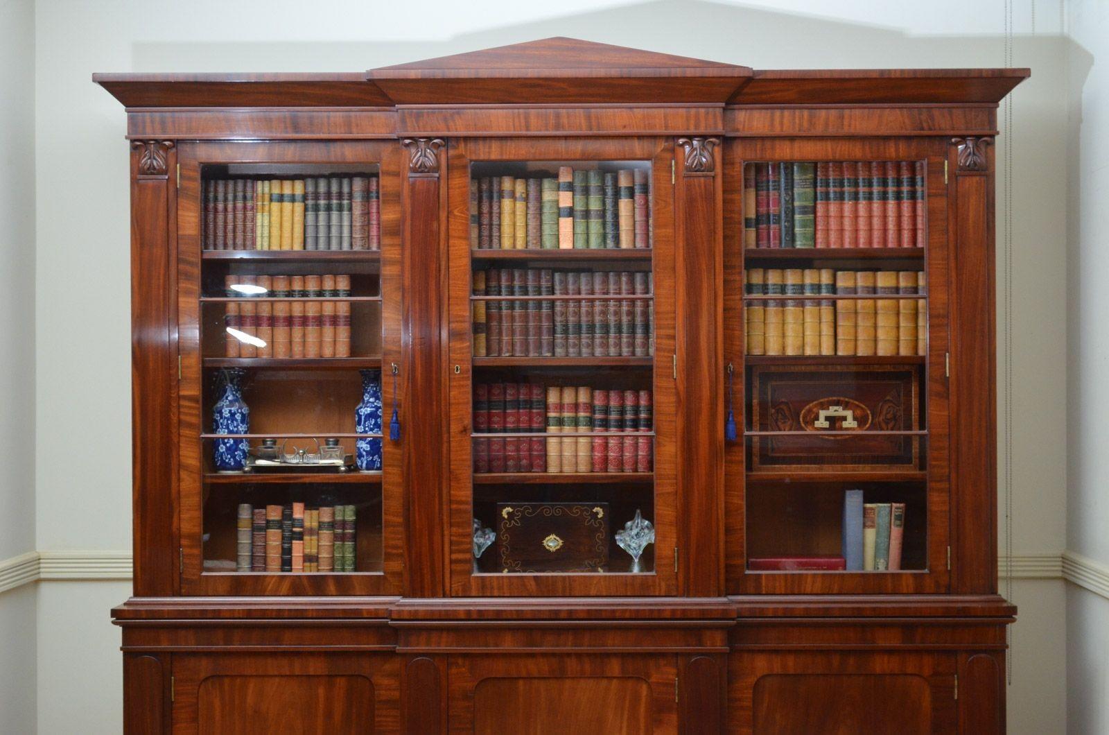 Sn4270 Stylish William IV mahogany library bookcase, having an architectural pediment (optional) above a projecting centre door flanked by pilaster with finely carved capitols and further cabinet doors, all enclosing height adjustable shelves and