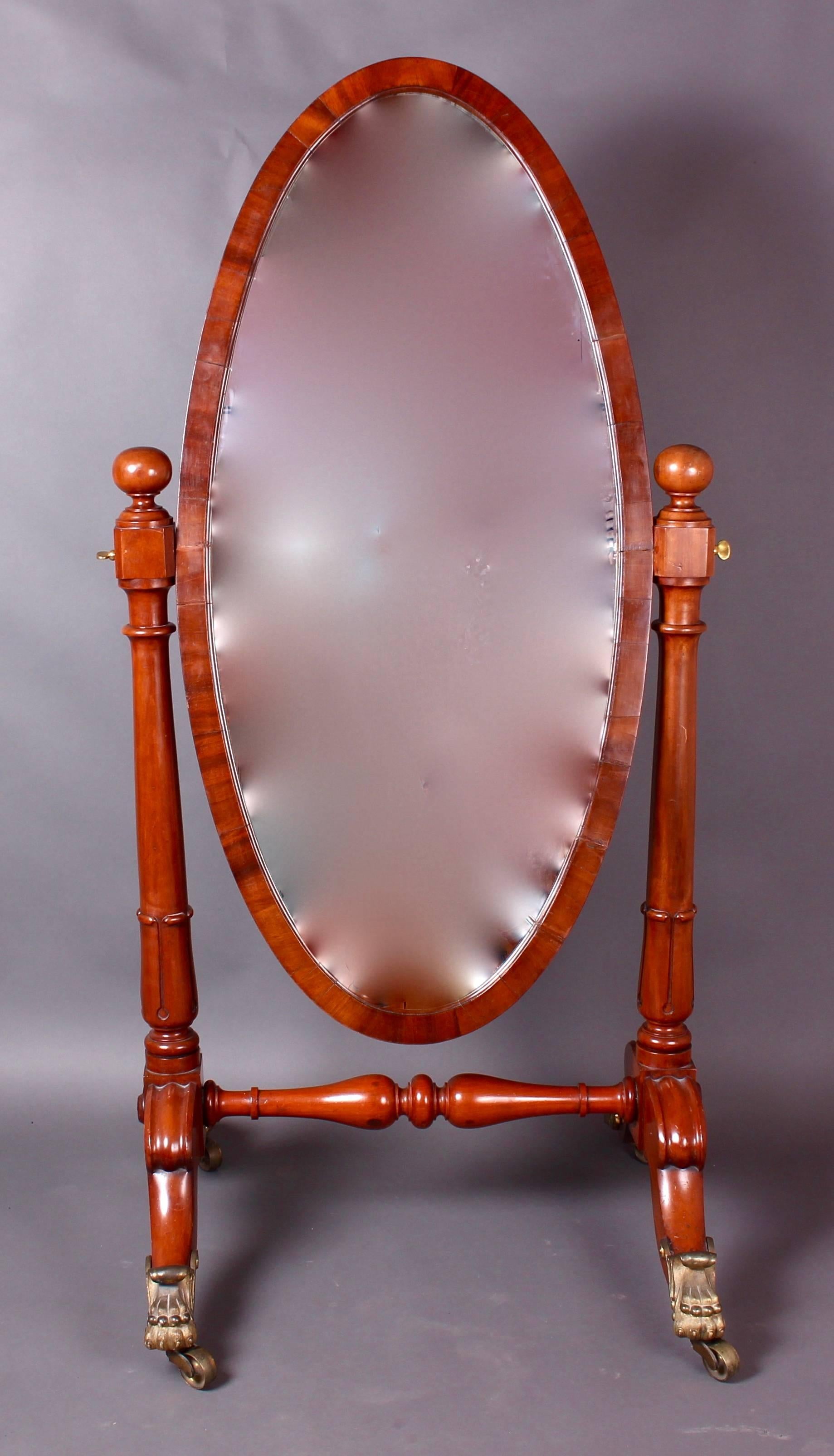 Stunning quality mahogany Cheval mirror, circa 1835. Large oval framed mirror. Flanked by nicely turned supports with carved leaf forms to the base and topped off with large block and ball finials. The whole supported on a handsome Stand, having