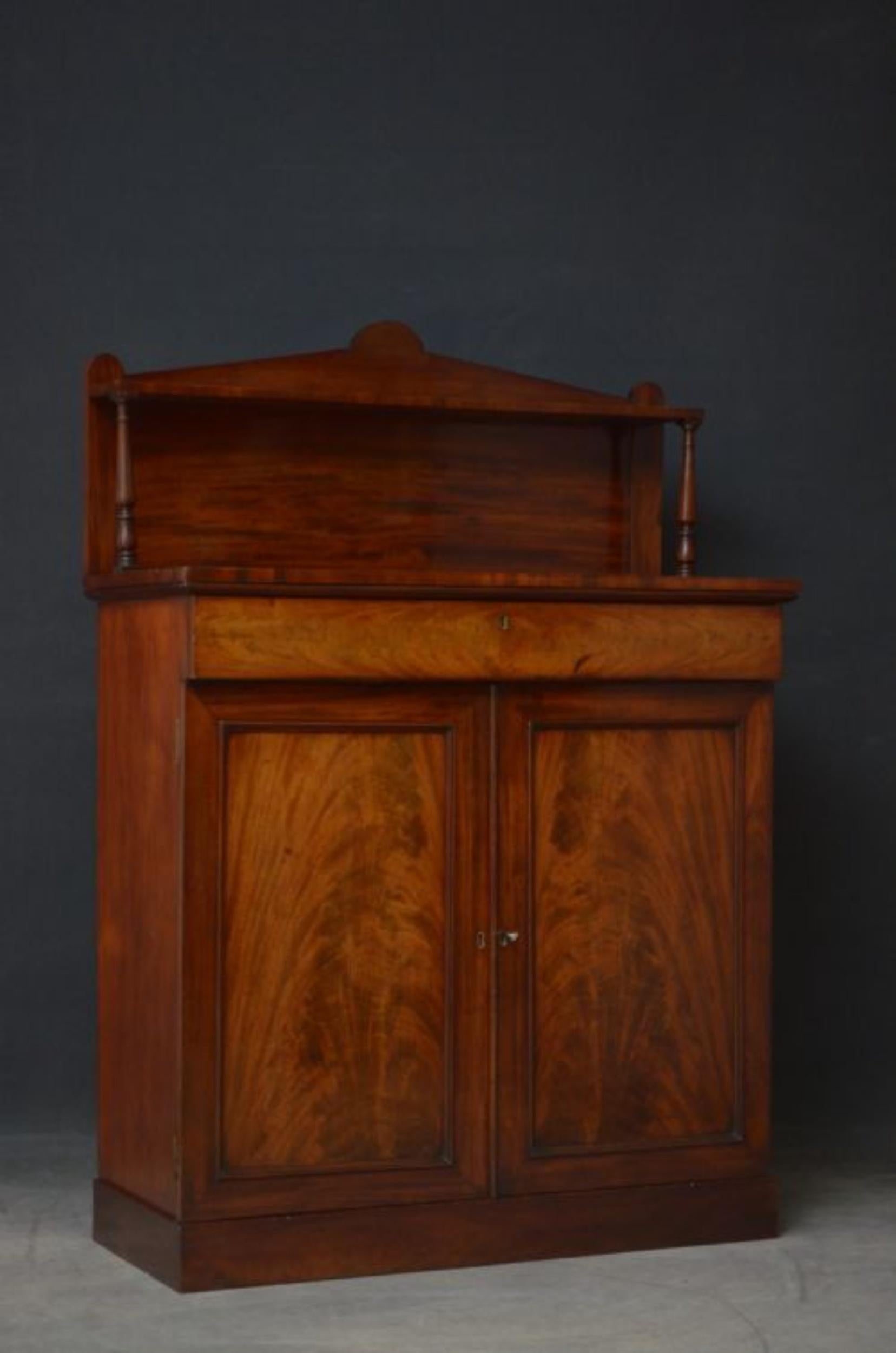 Sn4830 Elegant William IV chiffonier in mahogany, having architectural upstand on turned and ringed supports over figured mahogany top, flamed mahogany drawer and pair of panelled flamed mahogany doors fitted with working lock and a key and