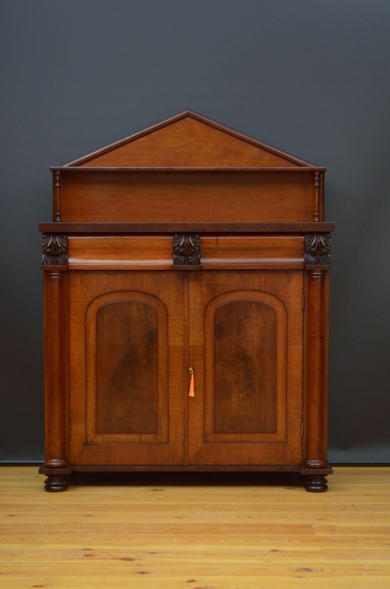 St019 William IV two door mahogany sideboard, having architectural pediment to the back, supported on turn columns, figured mahogany top and two shaped frieze drawers flanked with acanthus leaf carvings above a pair of panelled and arched figured