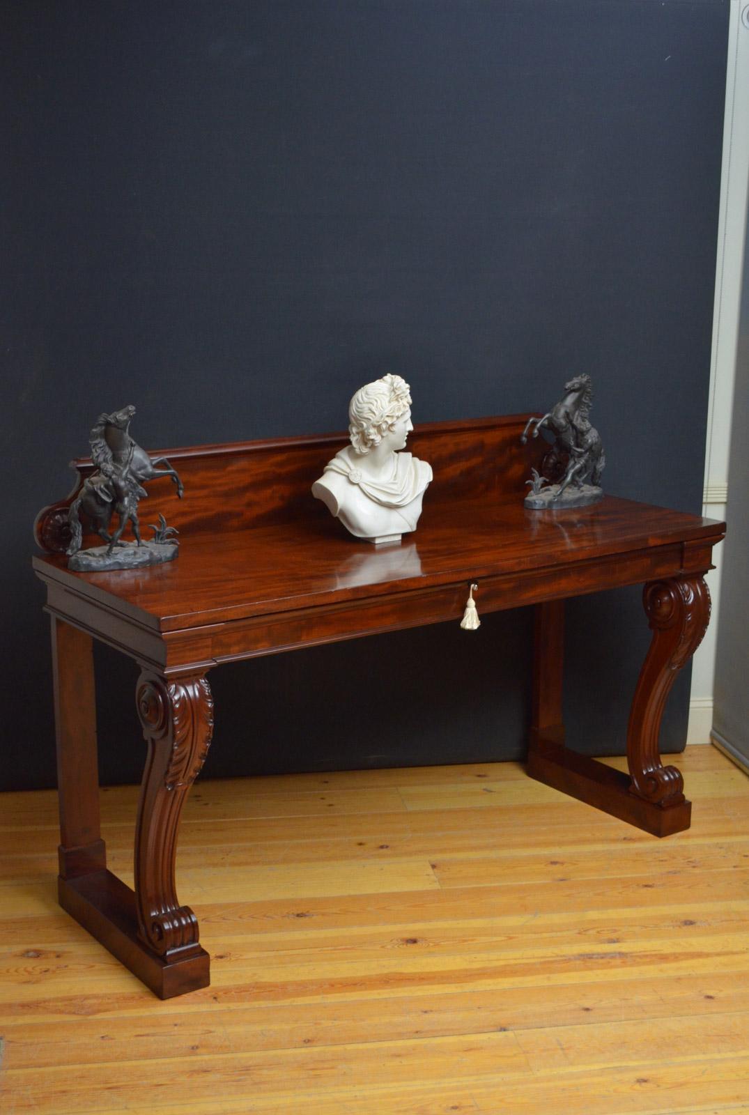 Sn4560 fine quality William IV, mahogany hall table, having figured mahogany upstand with carved pateras and stunning figured mahogany top above a molded drawer (key for decoration purposes only), all raised on beautifully carved legs terminating in