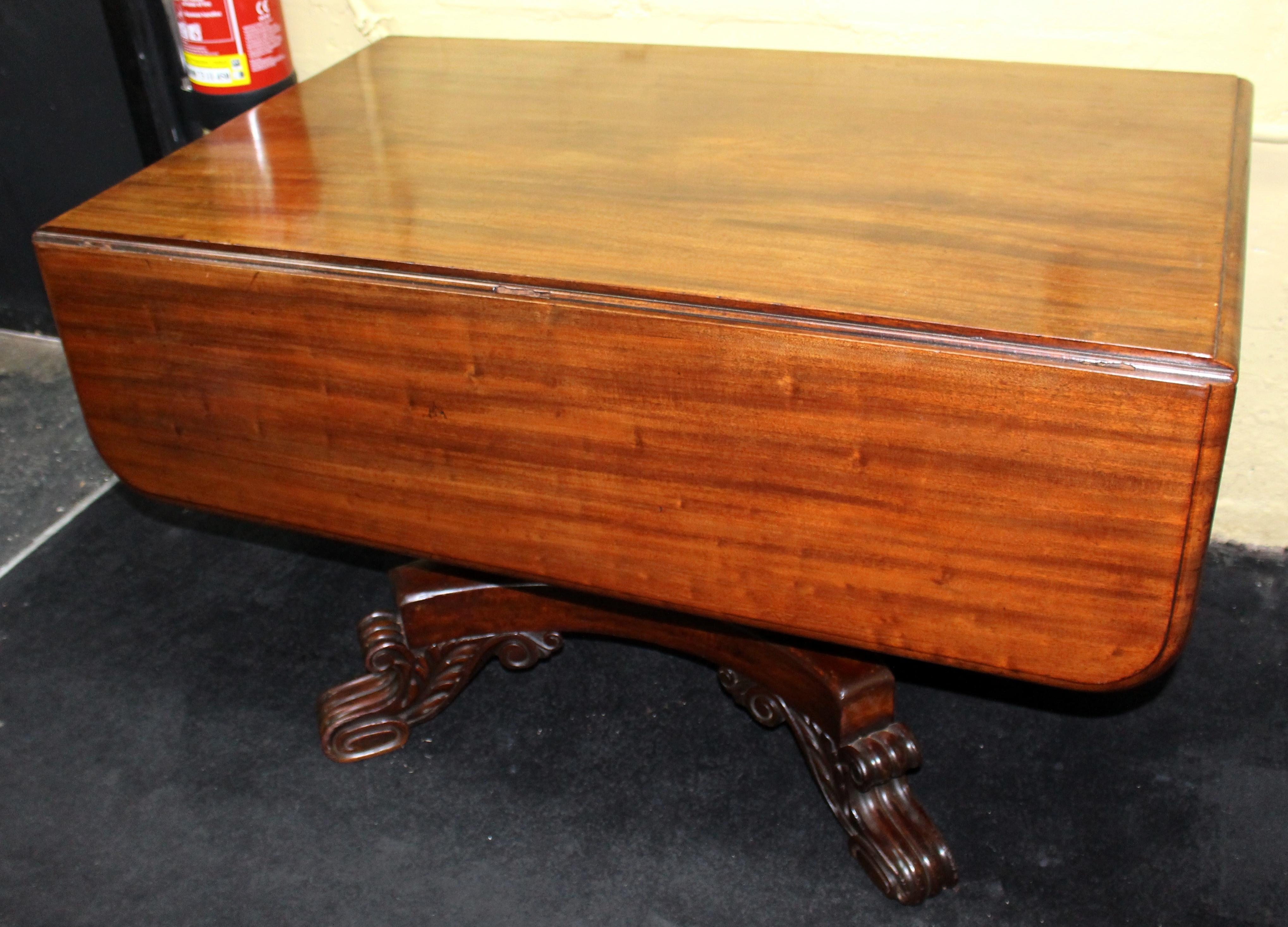 Antique mahogany Duncan Phyfe style centre table

Drop-leaves to either side, drawer to one end.

Heavily carved pedestal base and feet

Lovely patina and color to the timber, offered in very good condition

Many uses; centre table, library