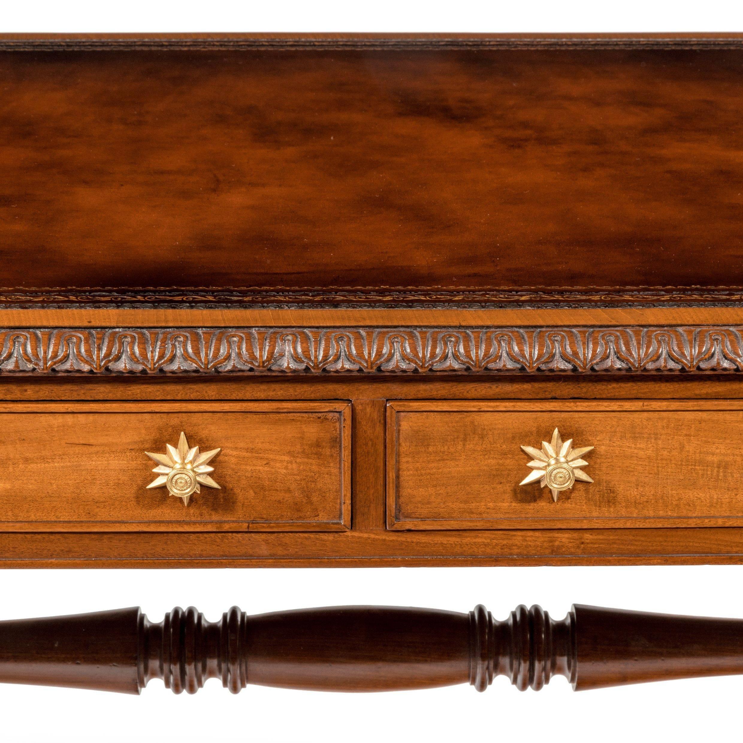 A William IV mahogany end support library table, the leather-inset top with rounded ends above two frieze drawers and two dummy cock-beaded drawers, raised upon twin C-scroll legs on bold lions paw feet and joined by a turned stretcher, English,