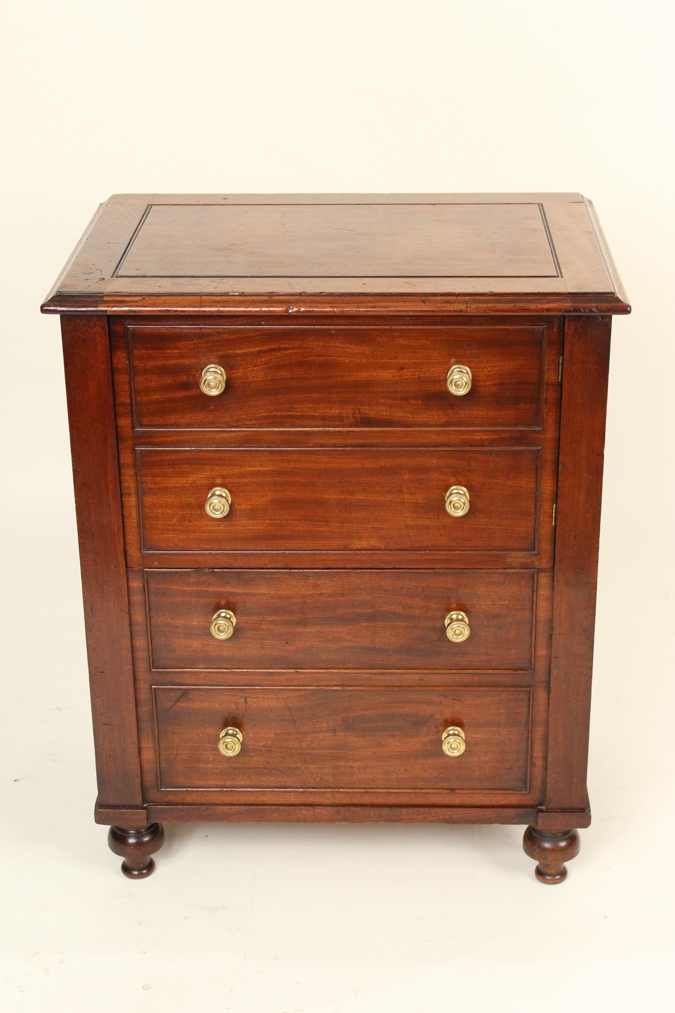 William IV mahogany occasional cabinet, circa 1830. The top two drawers are actually a door which opens and closes. The bottom two drawers are closed and does not open or close, this area can be used for storage. This cabinet would be an excellent