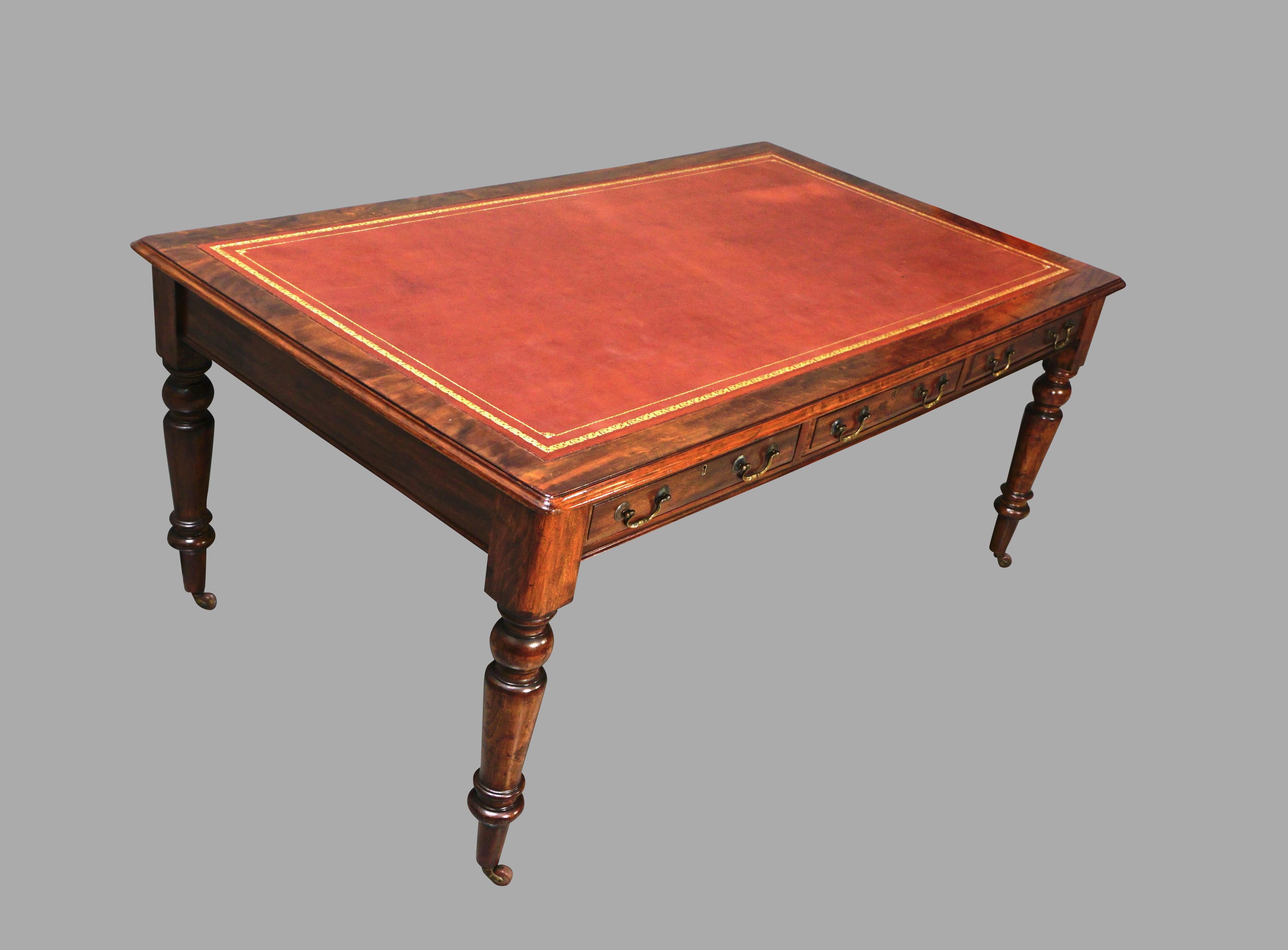 An English William IV or early Victorian period mahogany partners writing table, the brown gilt-tooled leather top above 3 drawers, the back identically configured, supported on turned legs ending in casters. Circa 1835-1850.