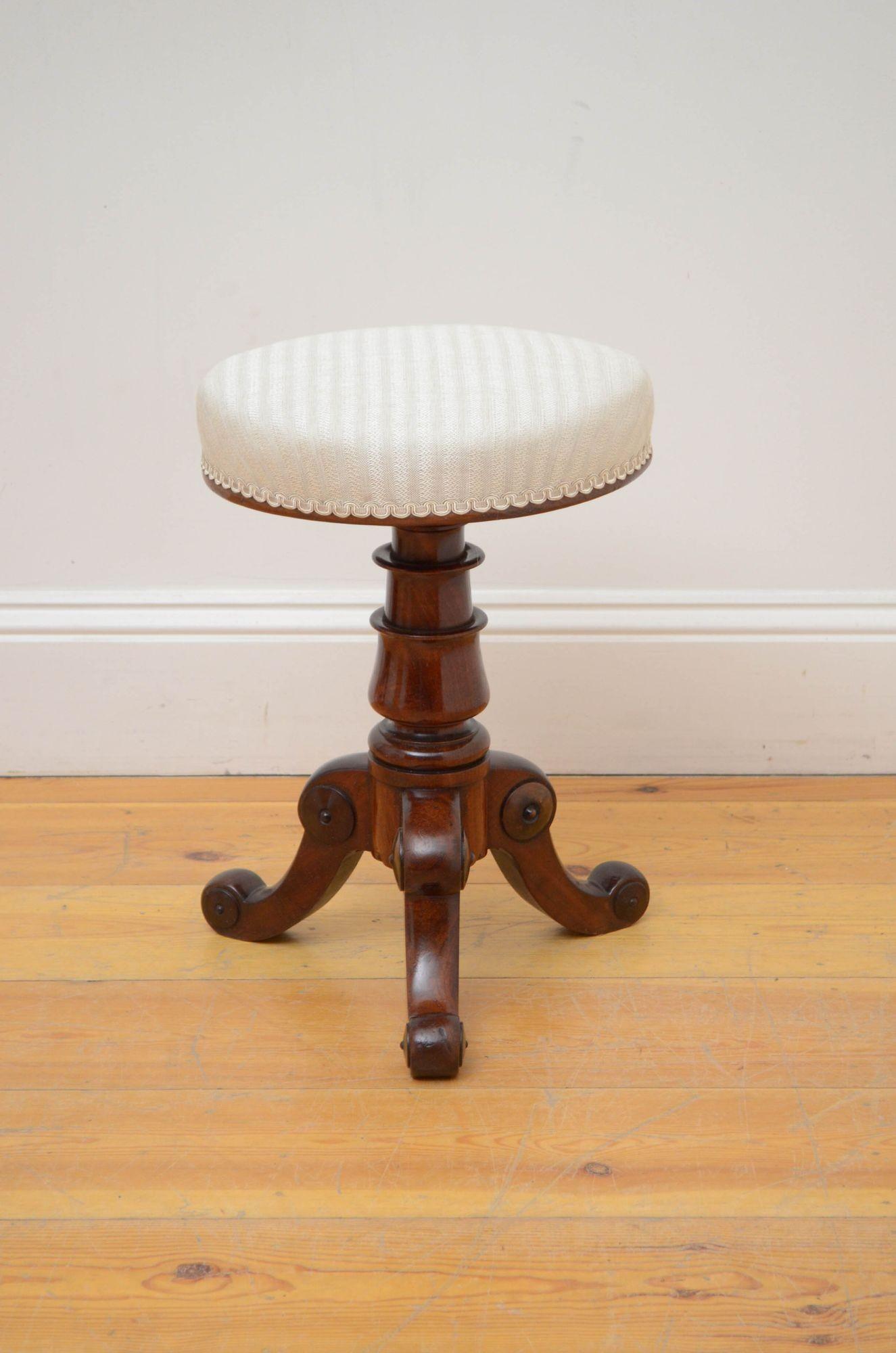 Sn5424 Elegant William IV mahogany piano stool or dressing table stool, having height adjustable revolving seat, newly recovered in stripy cream fabric, standing on vase shaped column terminating in three cabriole legs decorated with turned paterae.