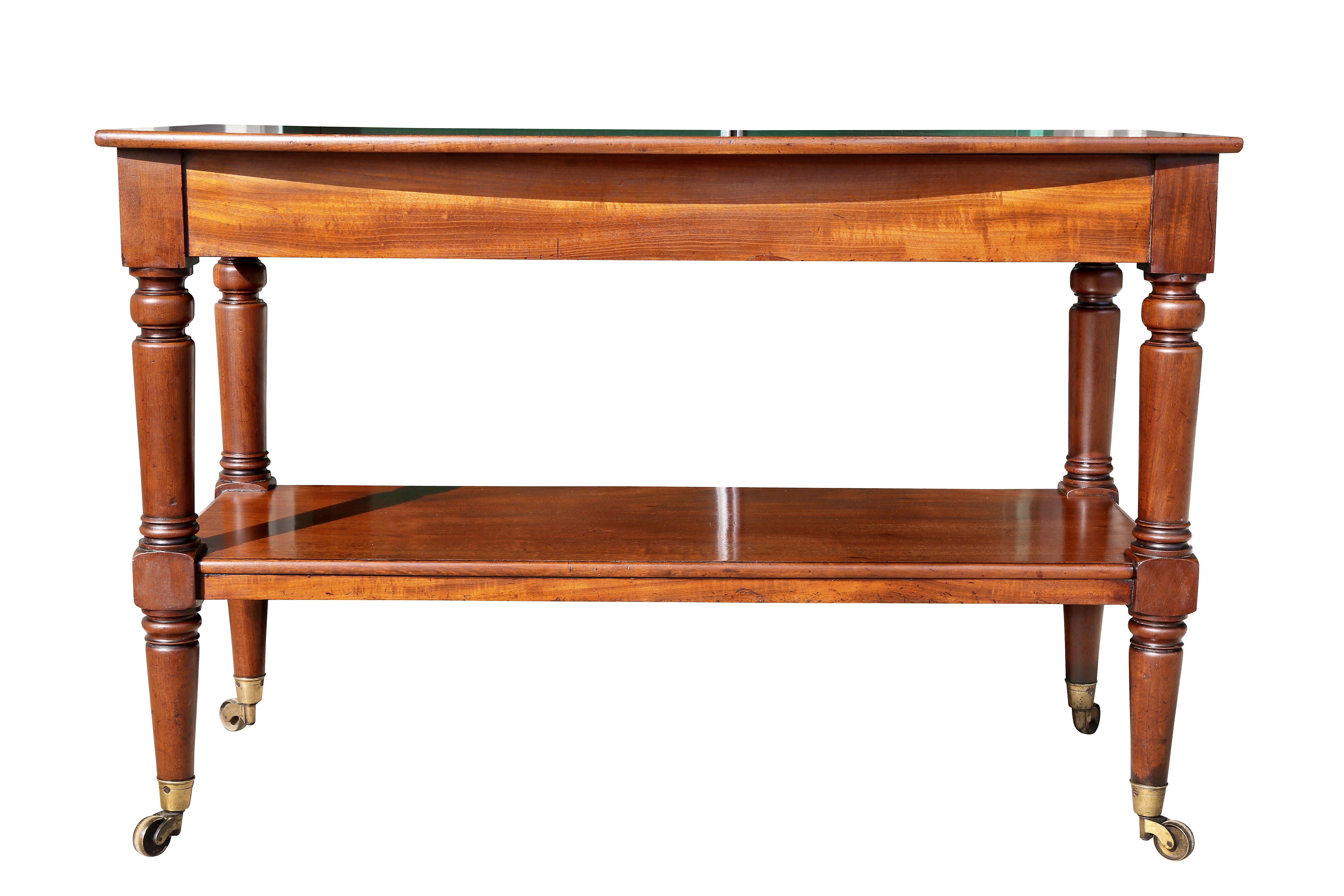 With bowed top with drawers at either end over a shelf, all with turned legs ending on casters.