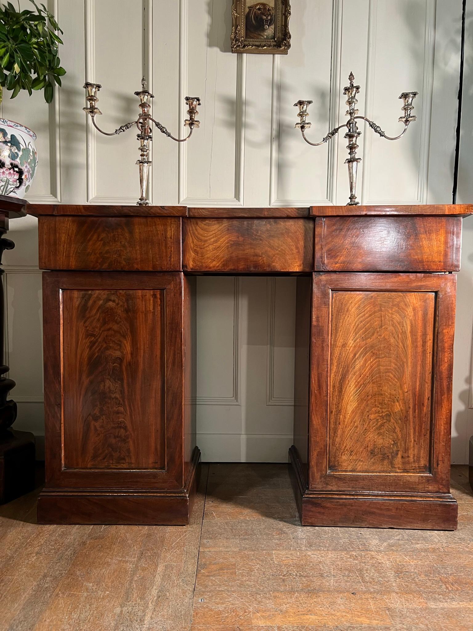 Unusually small William IV figured mahogany pedestal sideboard or buffet.

The diminutive proportions enable this piece to be used in a smaller dining room or as a console table in a hallway.

Cupboard doors open to reveal additional storage