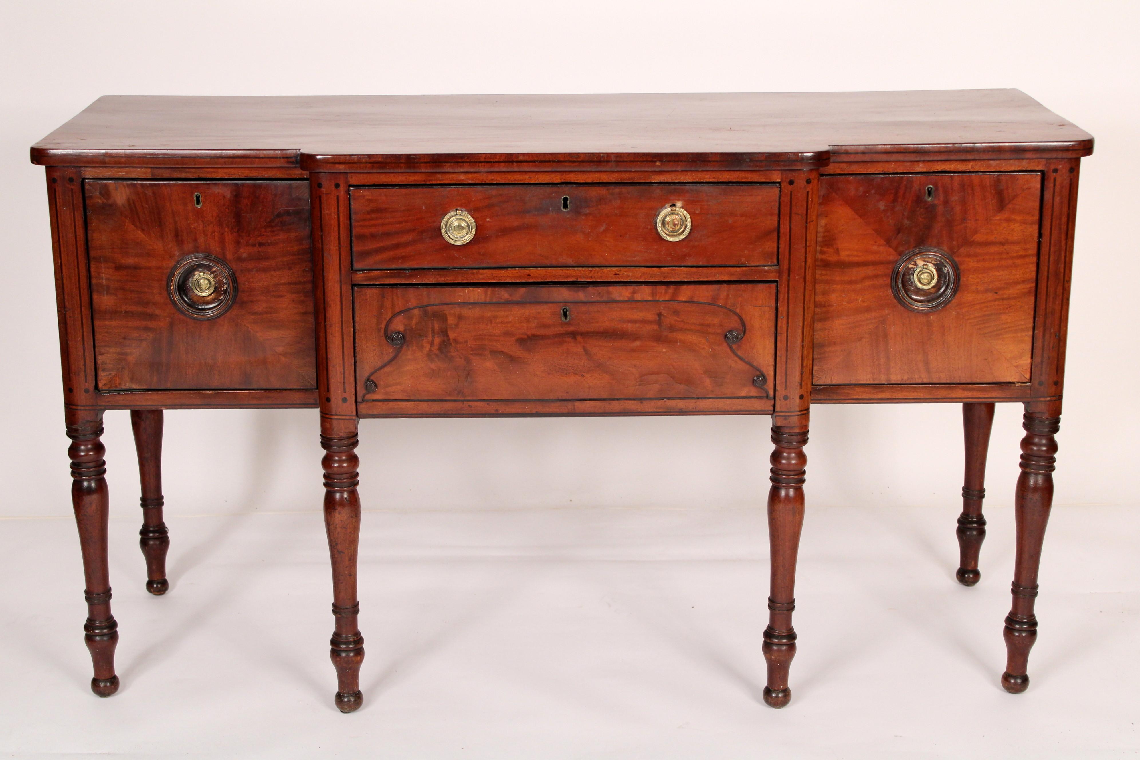 William IV mahogany sideboard, circa 1830.  The front having a door on the left side and a door on the right side the center section has two drawers. Resting on turned legs. Excellent quality mahogany used on the front drawers and door. The mahogany